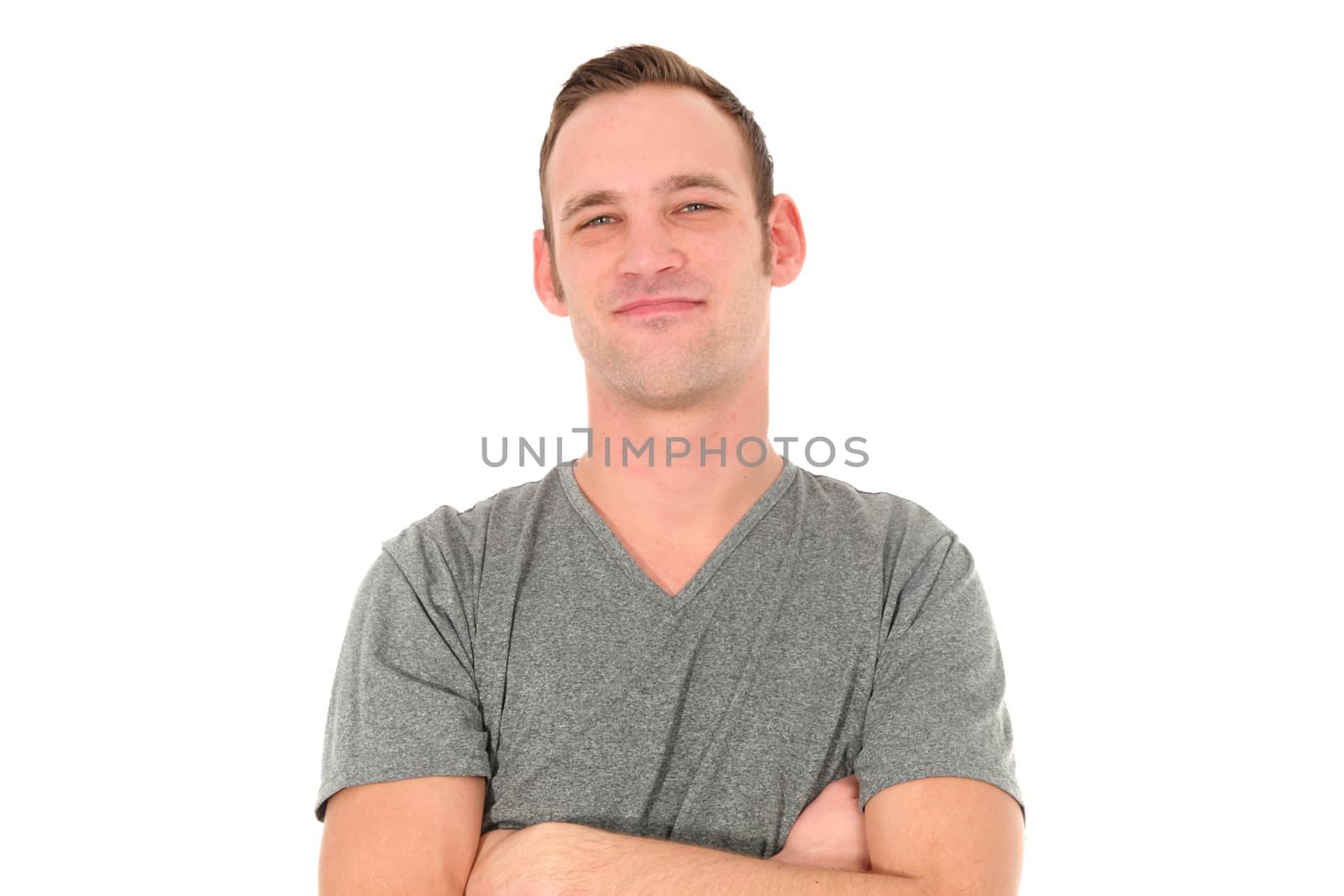 Attractive smiling man with arms folded isolated on white