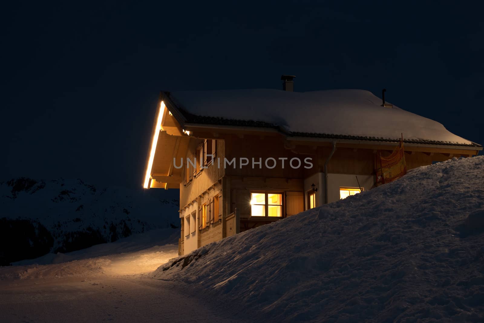 Beautiful skiing hut at night in a valley of Montafon, photo taken from public skiing piste