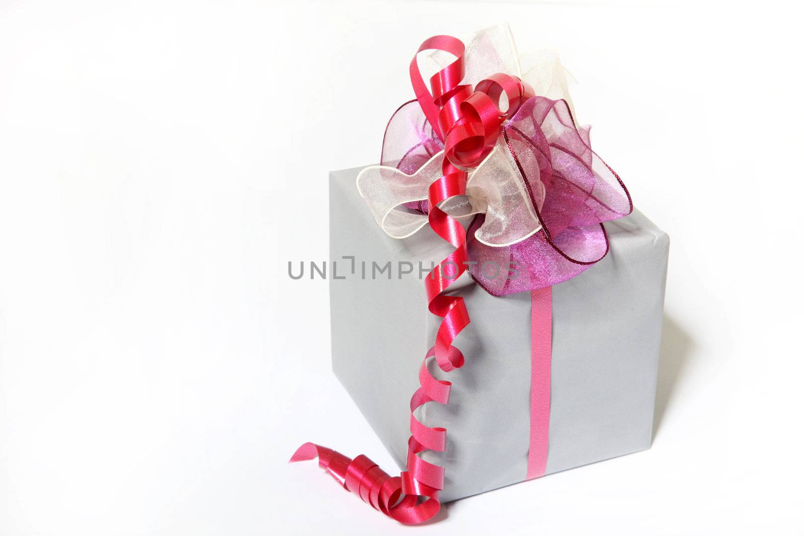 A beautifully wrapped gift with bow on white background