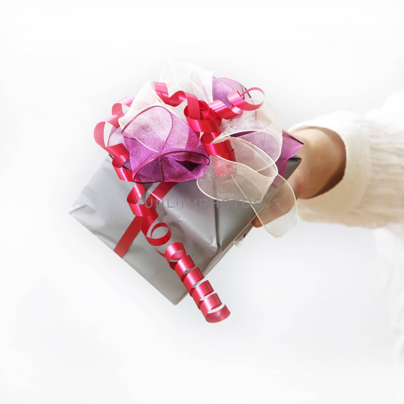 Woman shows nice gift with bow - white background


