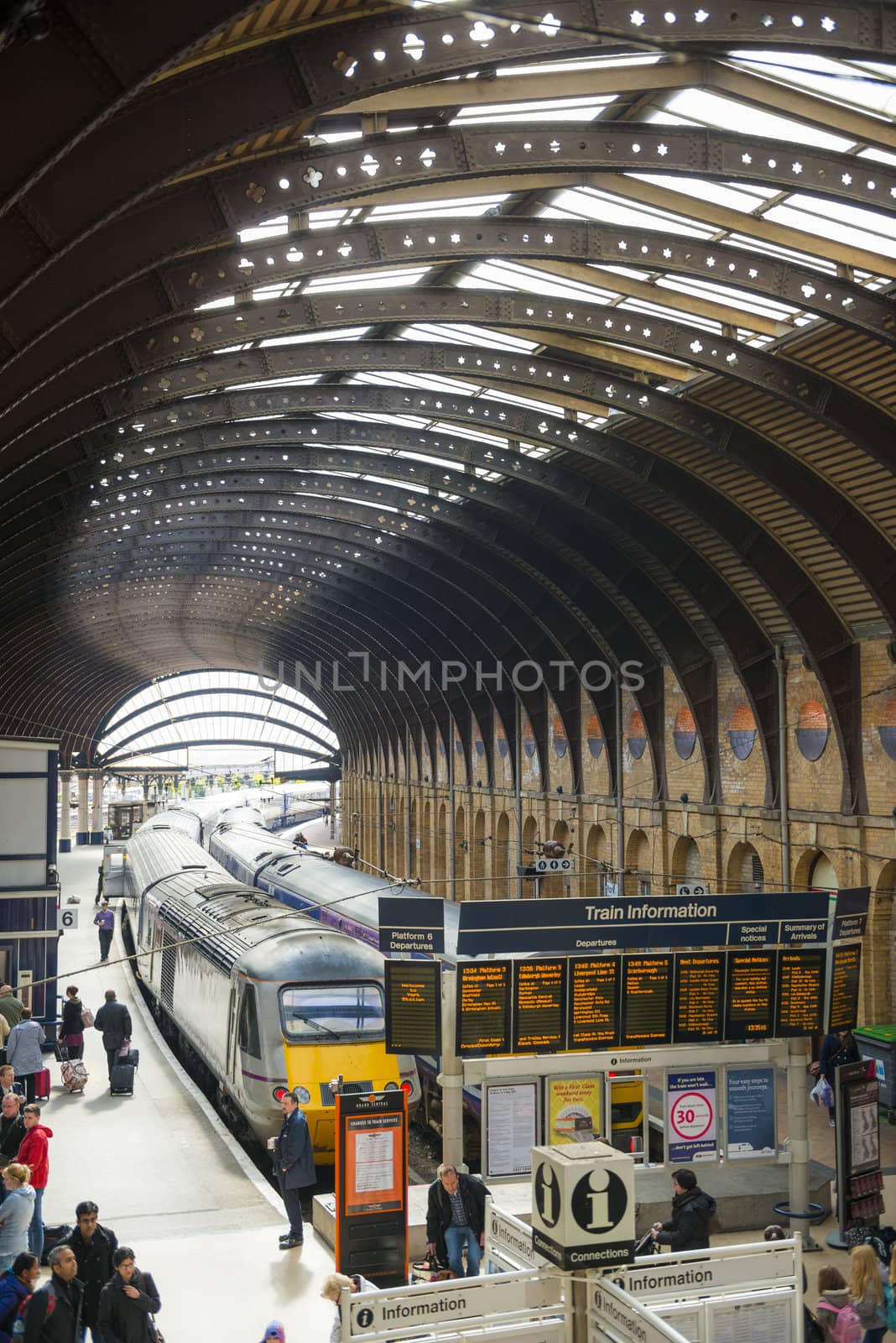 YORK, UK - MARCH 29: Trains at platform in York Railway Station. Inaugurated in 1877 and bombed during WW2, it is one of the most important railway junctions in the British network. March 29, 2013 in York.