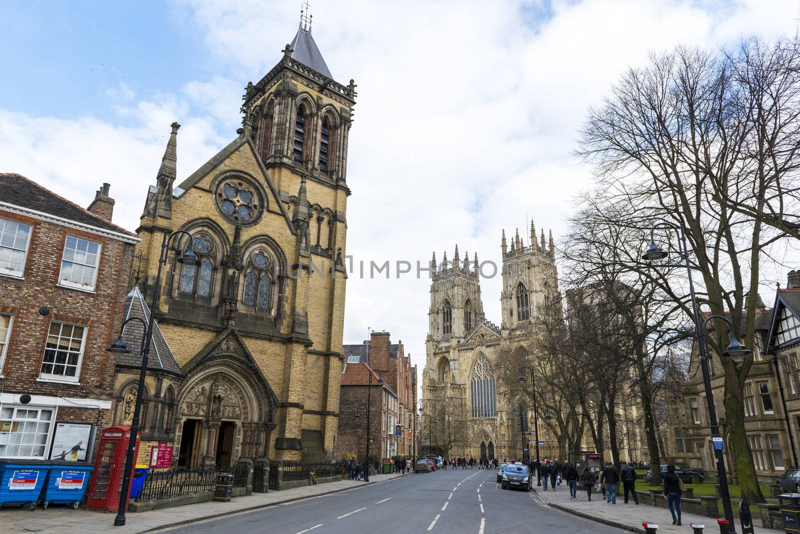 YORK, UK - MARCH 29: Street view from Dumcombe Place showing Saint Wilfrid's Church and York Minster at the back. March 29, 2013 in York.