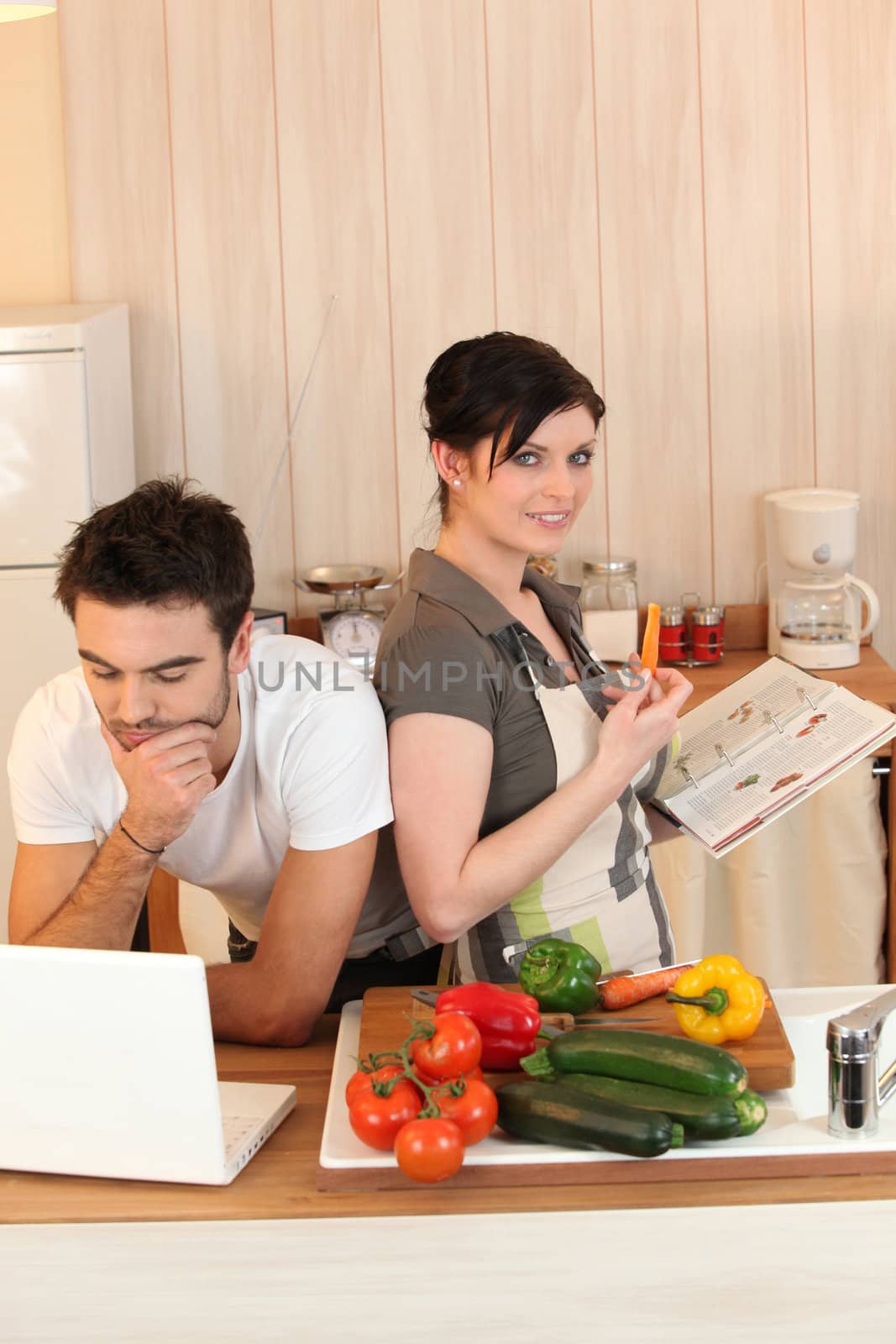 Couple looking at recipes by phovoir