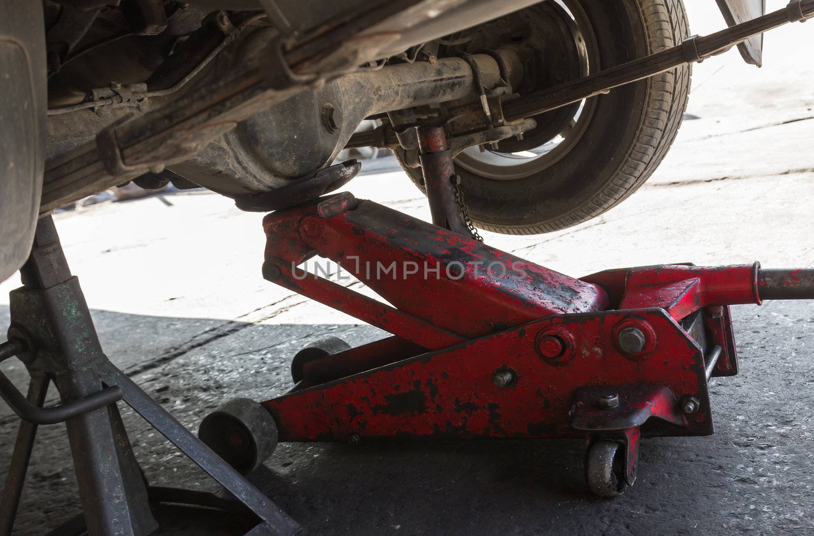 Car with tire at jack in service