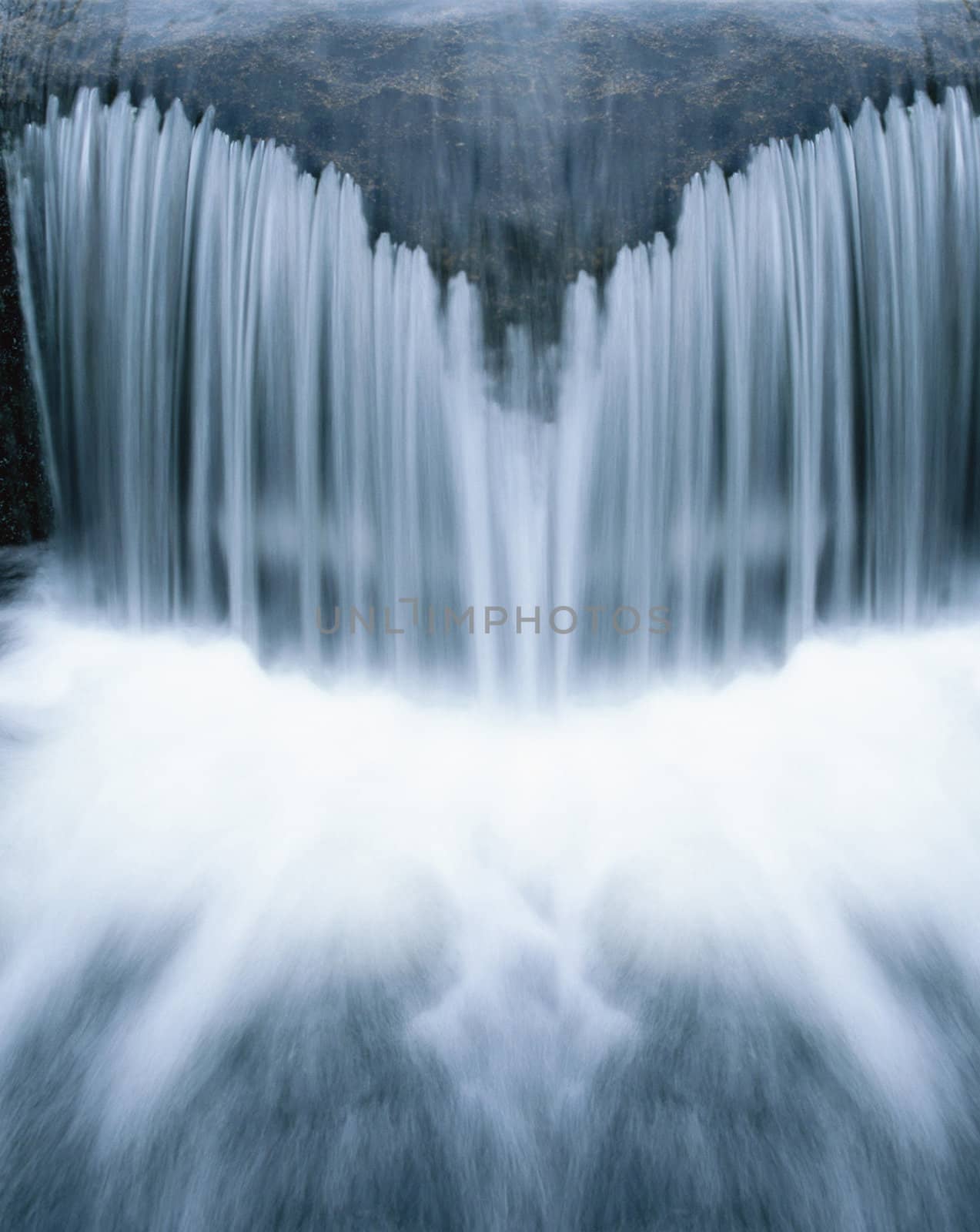 Beautiful cascading waterfall over natural rocks