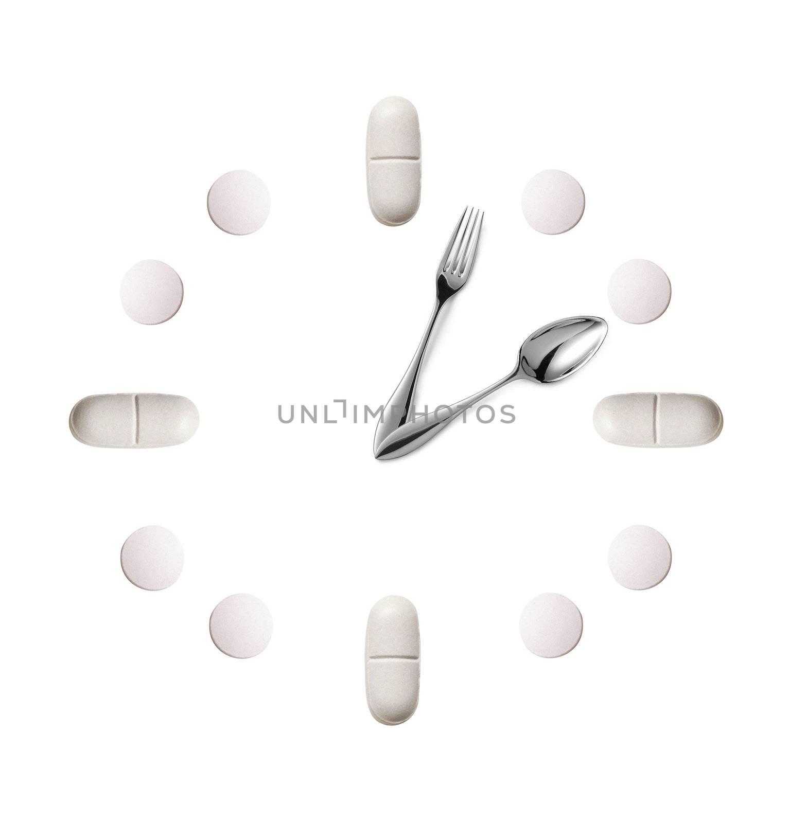watch made up out of white tablets and fork with spoon