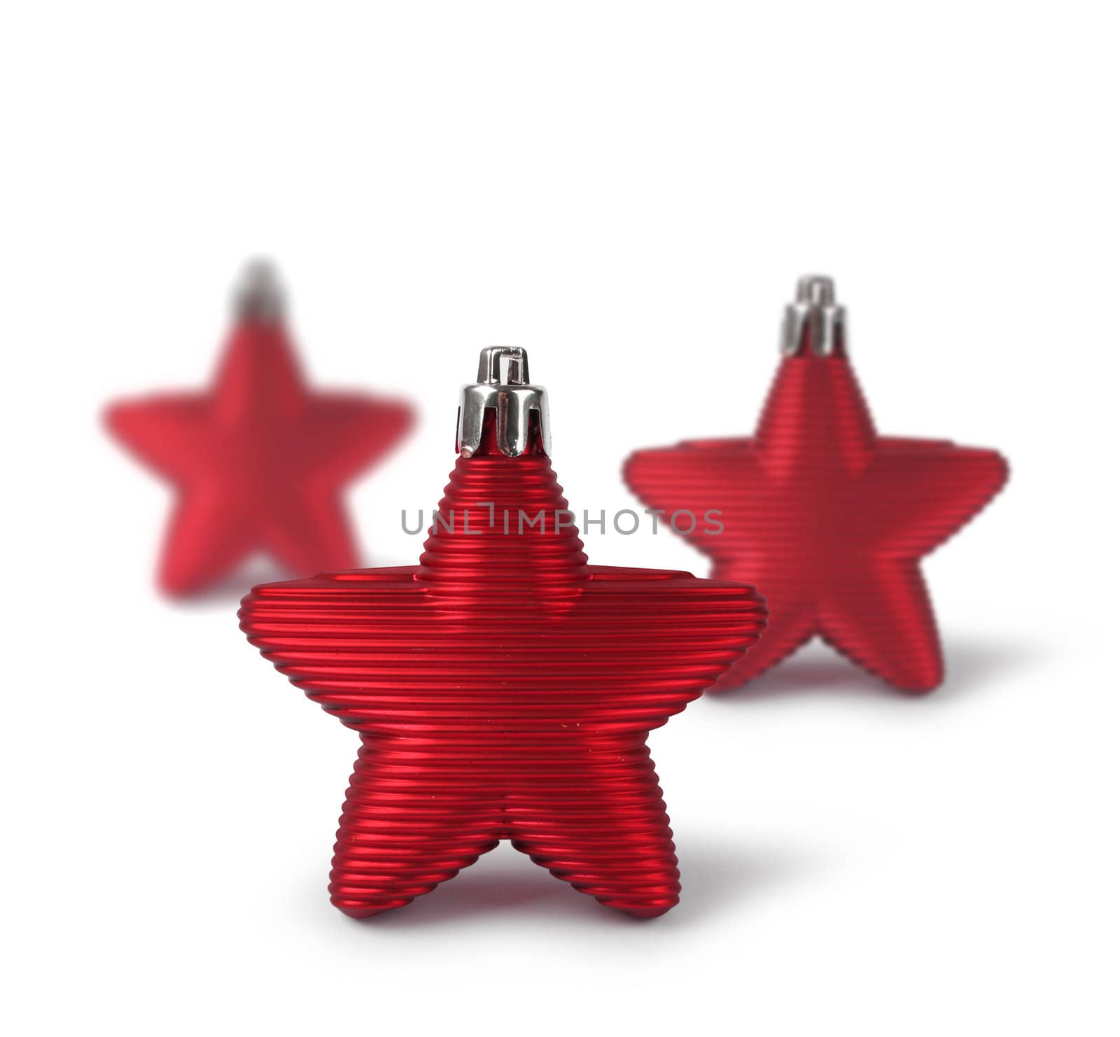Three red Christmas decoration stars isolated on white background