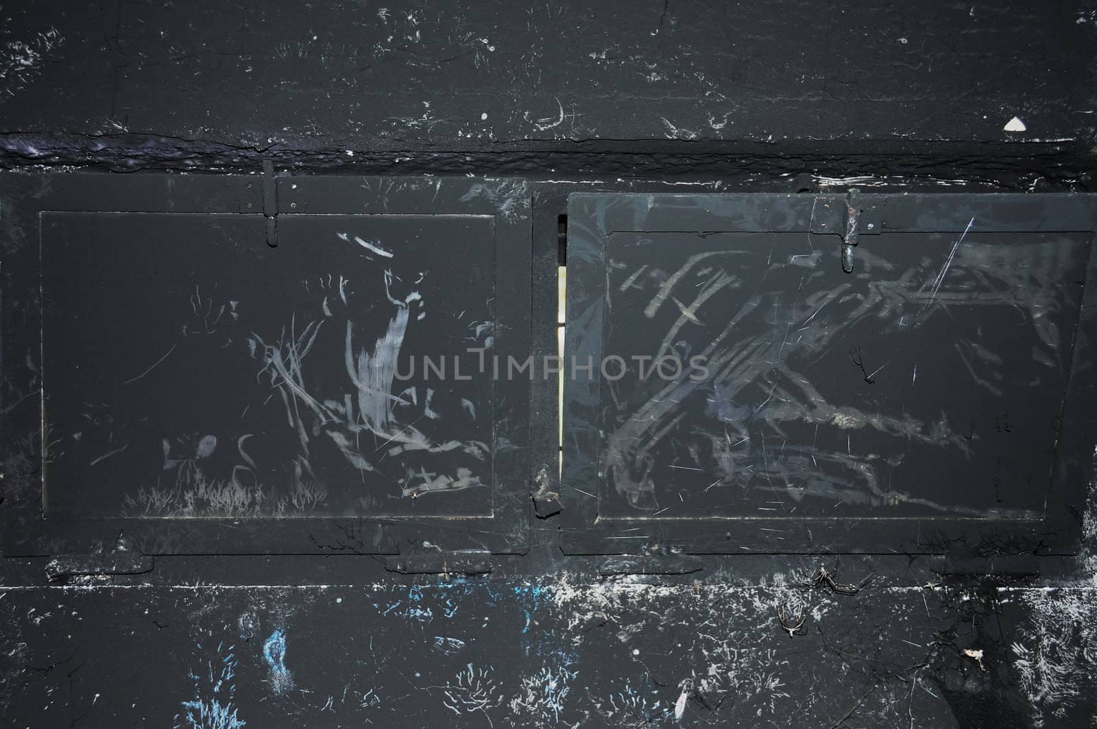Black wall and charred window glass. Burned house interior.
