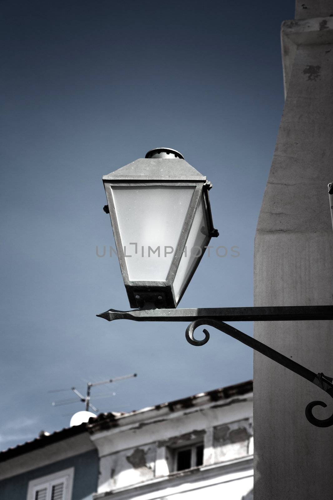 old street-lamp on house background by motorolka