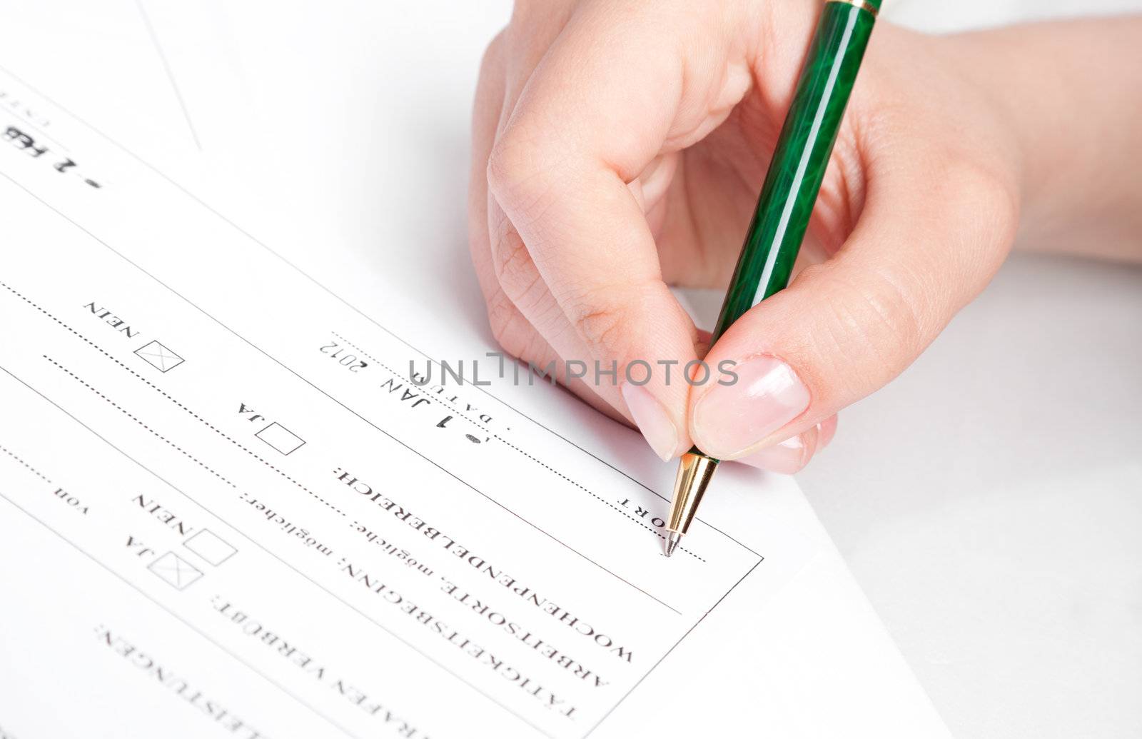 Female hand signing contract.