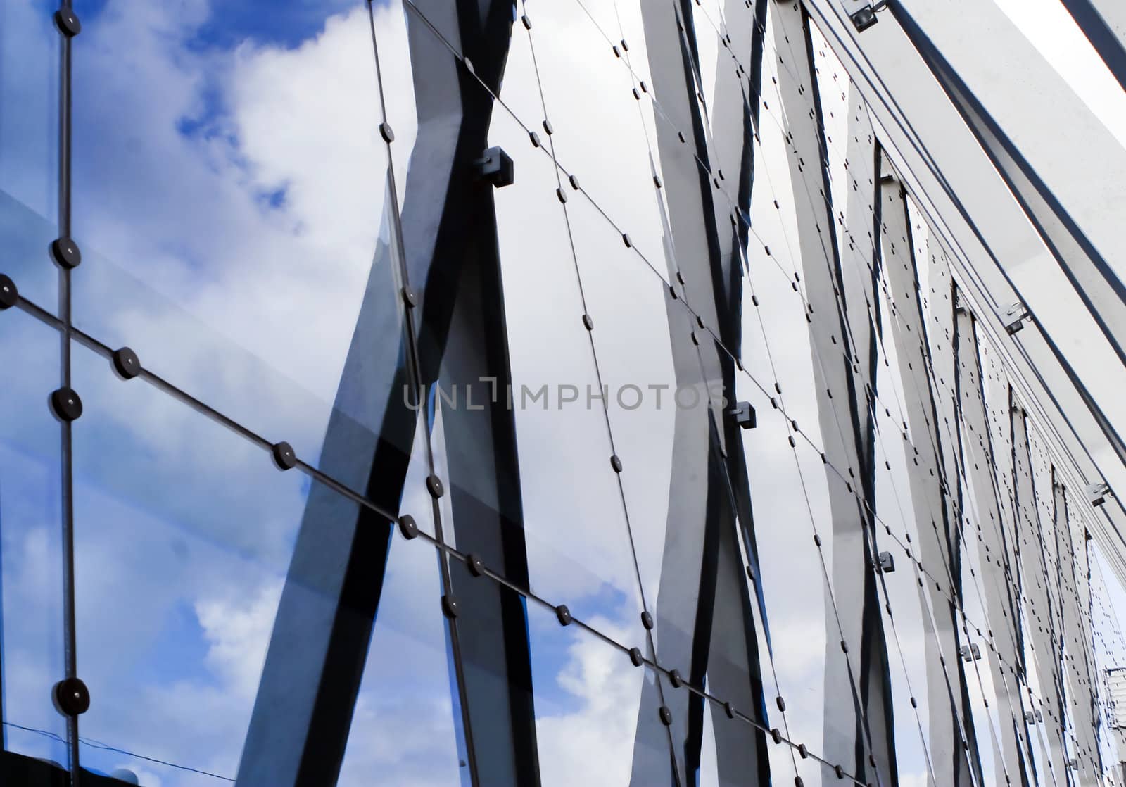 Urban composition with glass, stone, steel and blue sky.