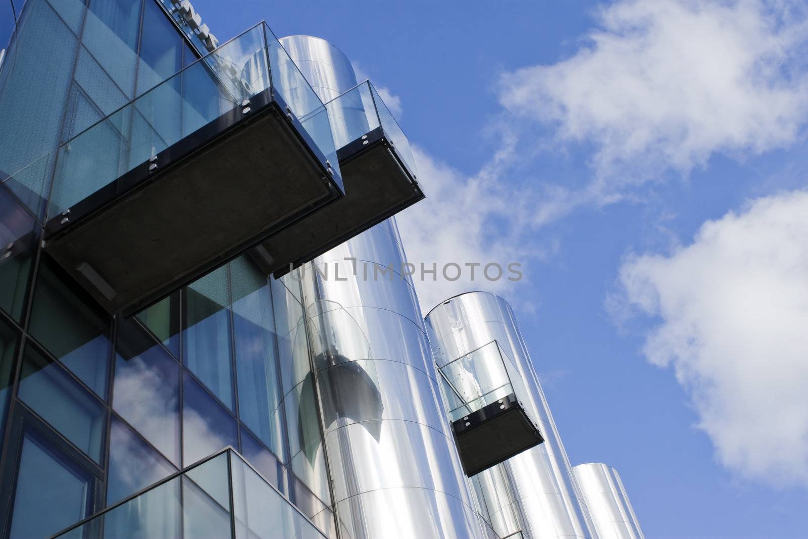 Futuristic building with balcony and deep blue sky.