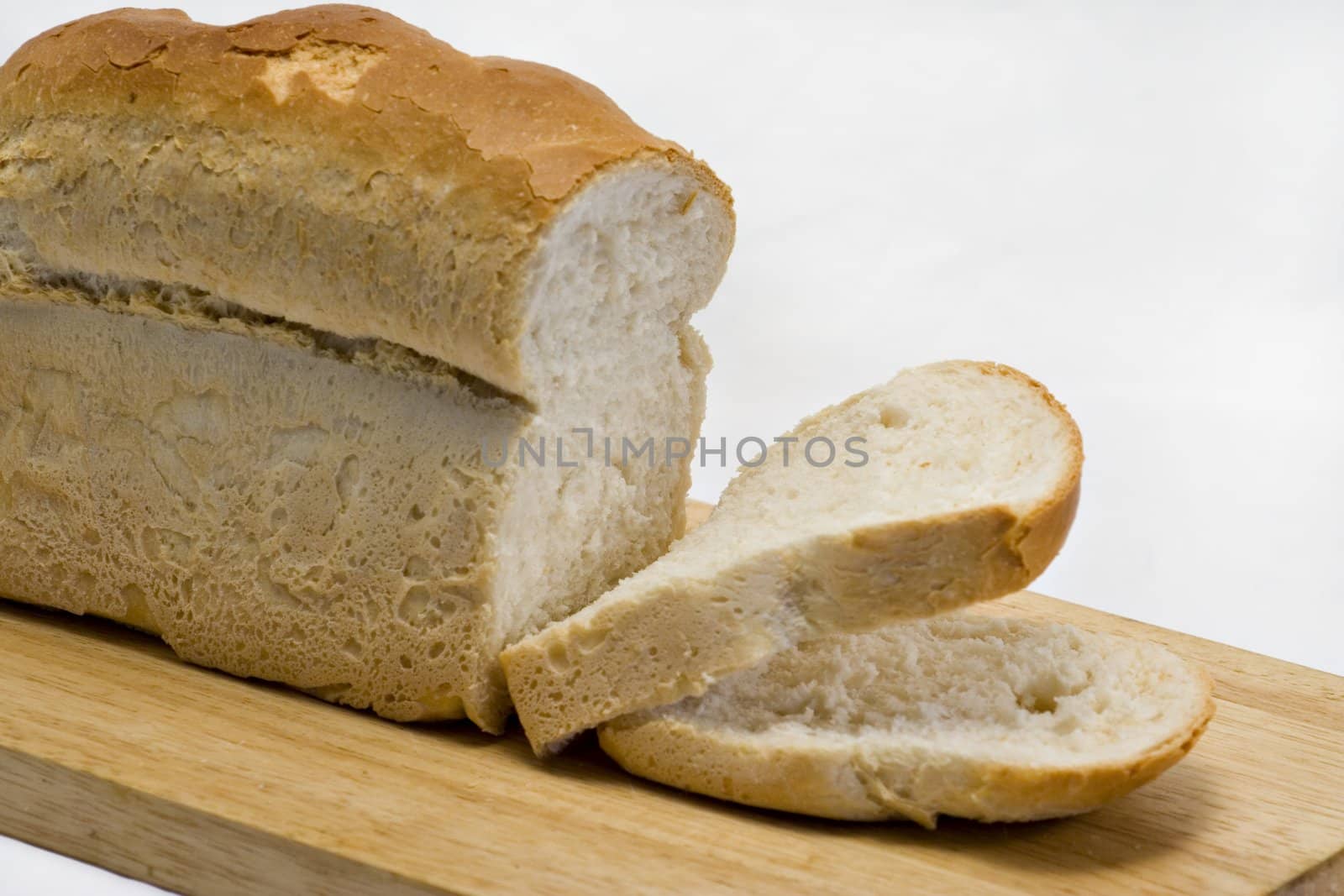 A fresh cut loaf on a wooden board