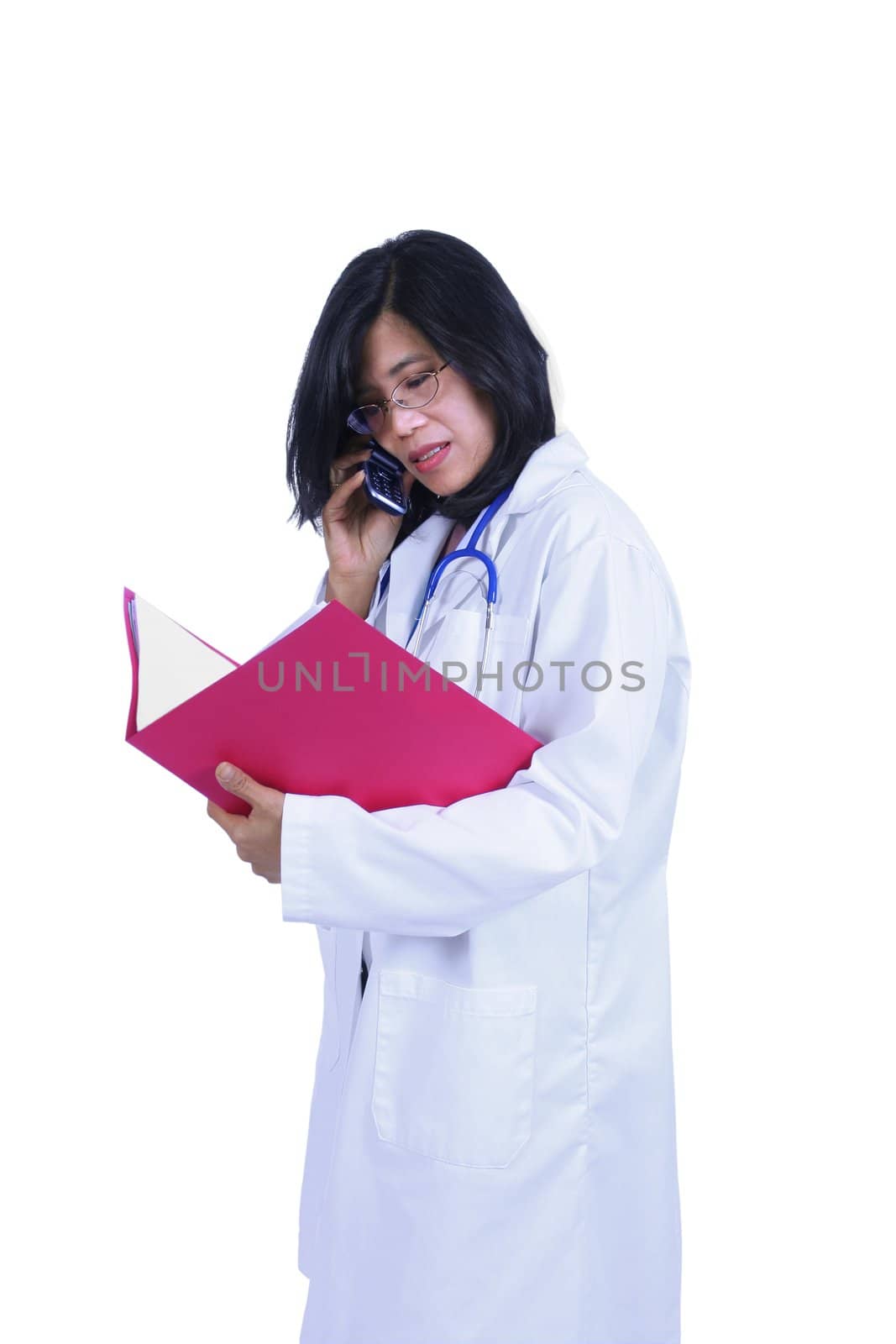 Asian female doctor talking on cell phone and holding files