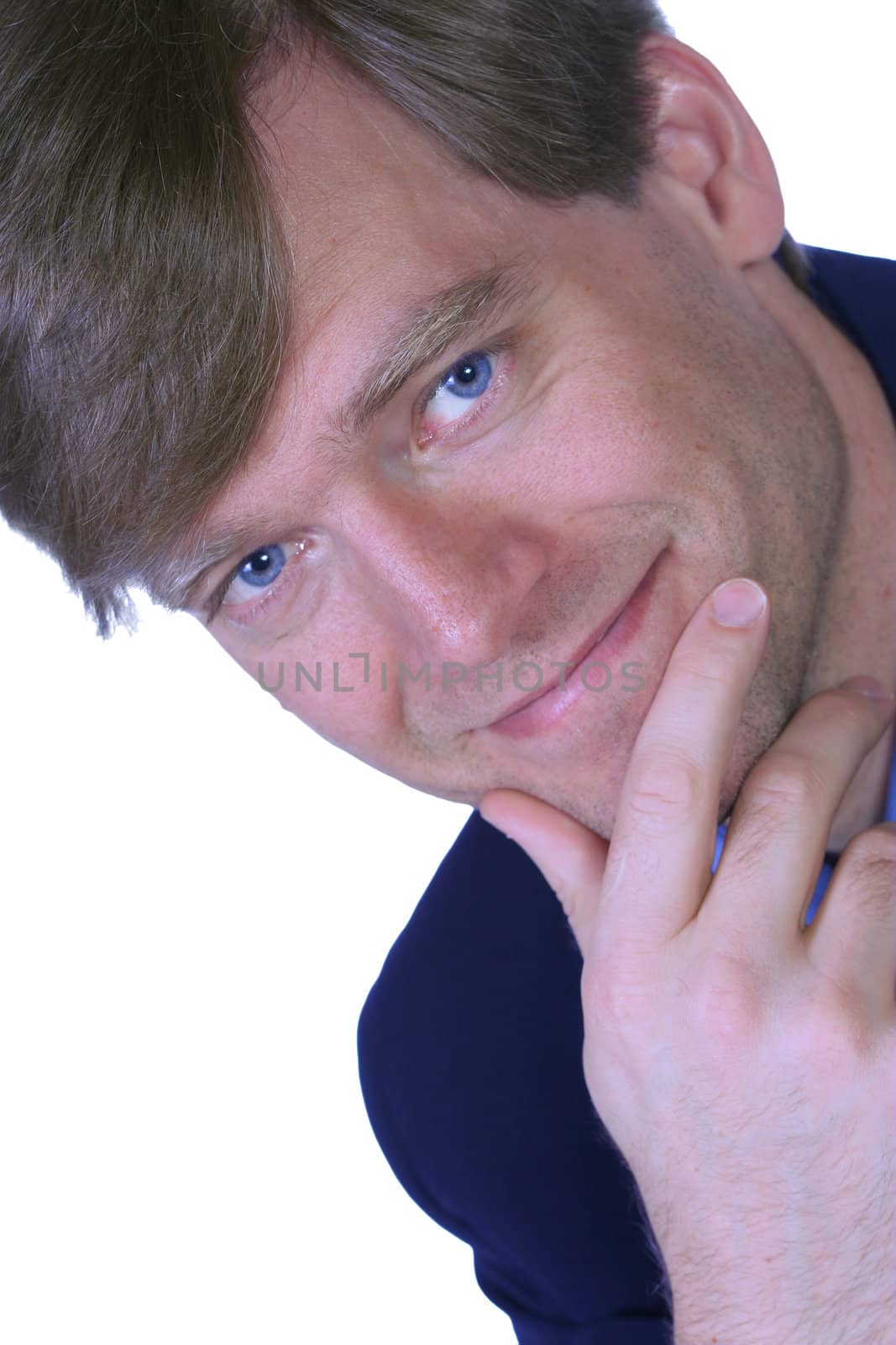 Handsome businessman with slight smile, posing chin on hand