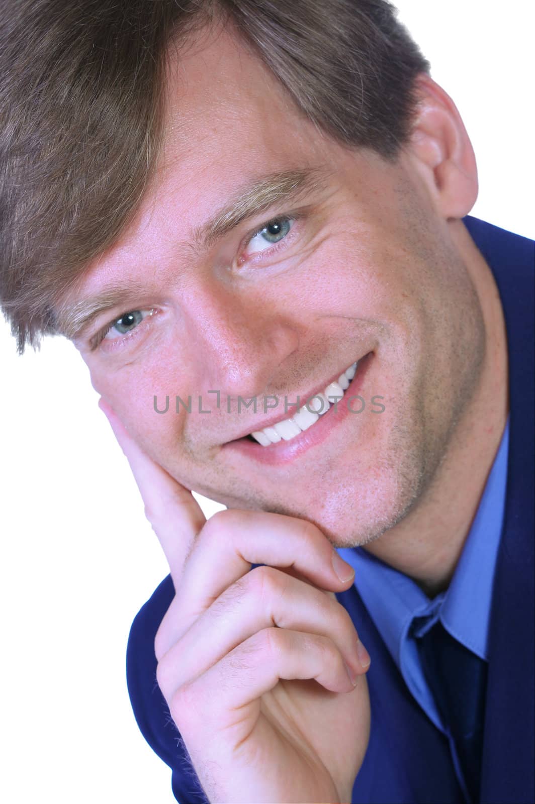 Handsome businessman smiling and laughing, chin on hand