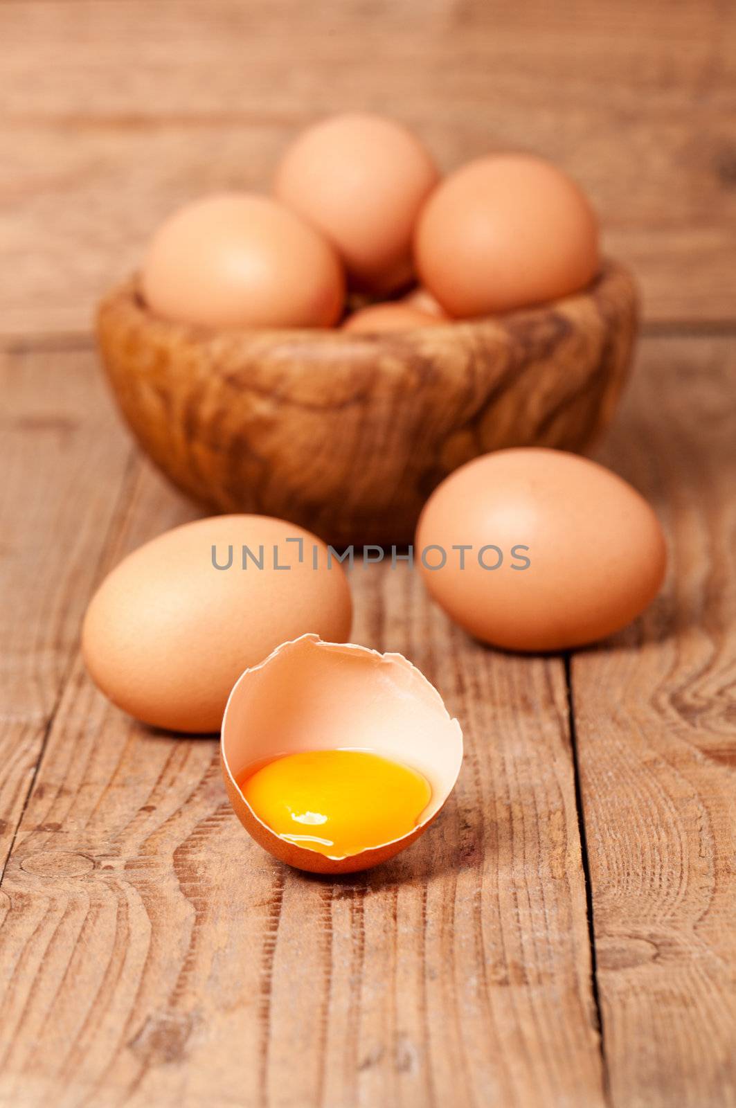 yolk of egg on wooden background by motorolka