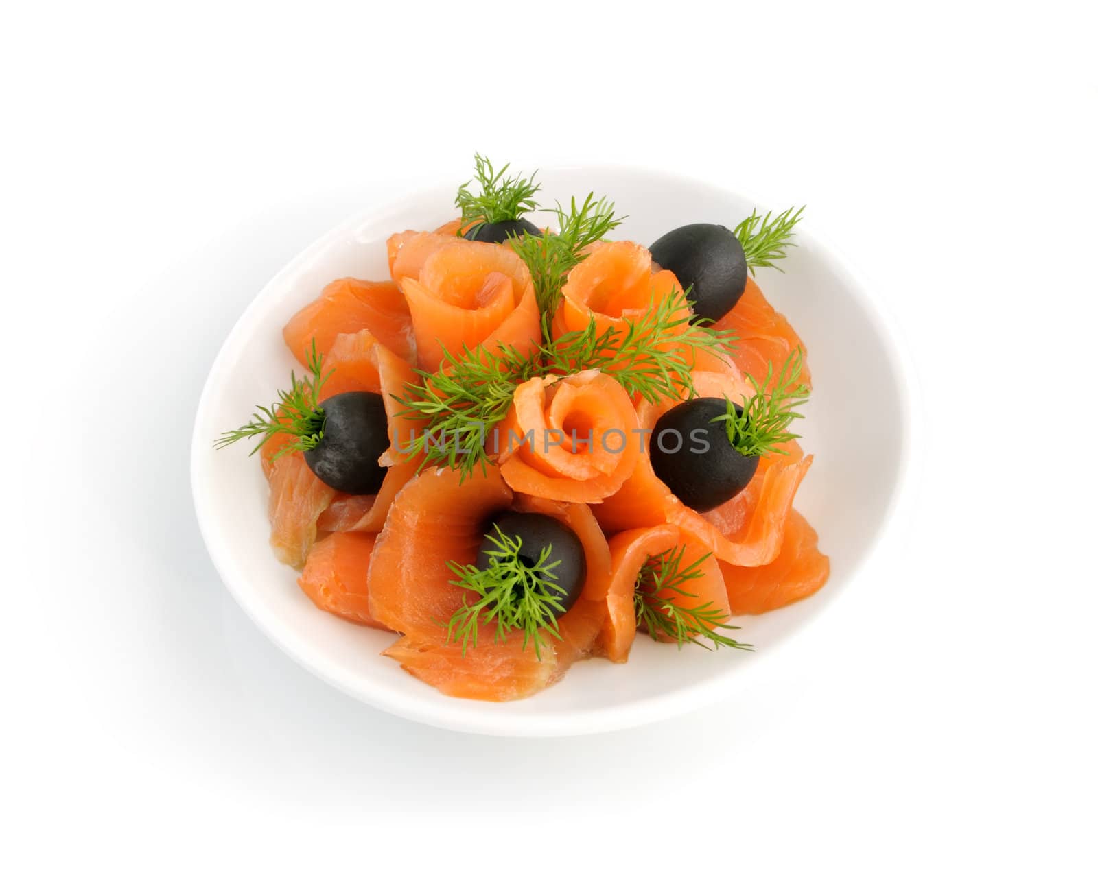 Appetizer of salmon with fennel and olives on a white background