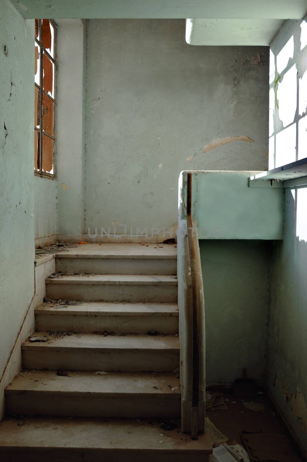 Dirty staircase and peeling walls. Abandoned building interior.