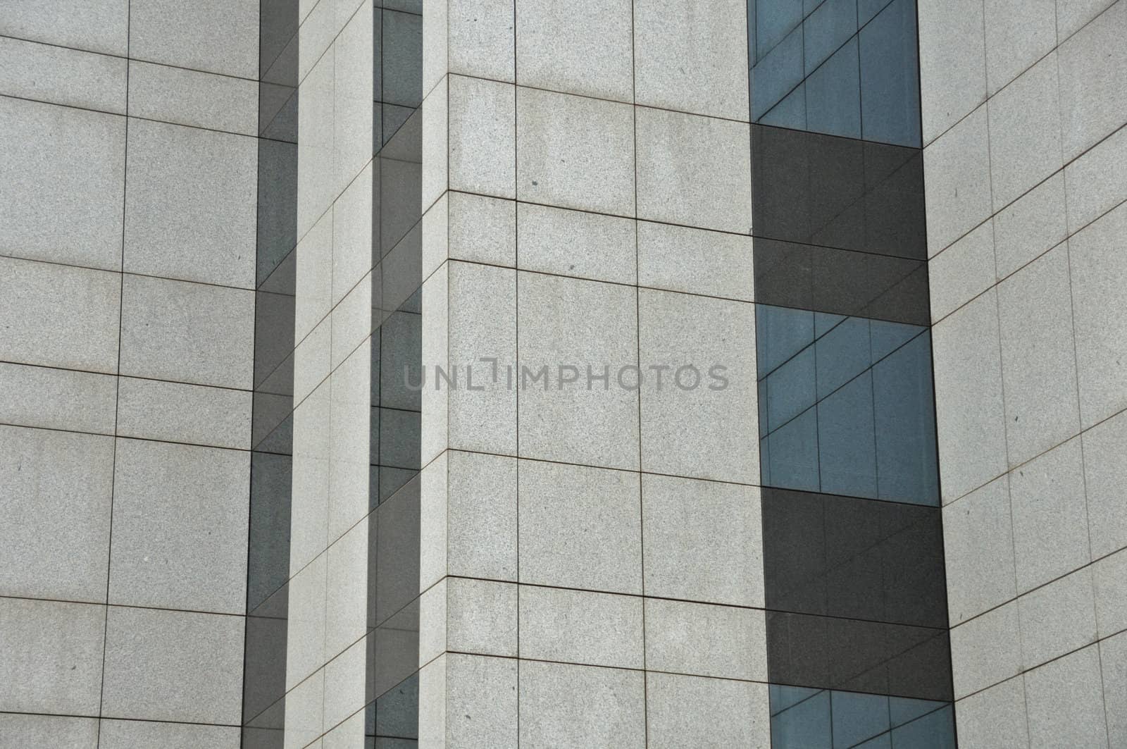 Windows and wall of a modern glass building. Architectural detail.