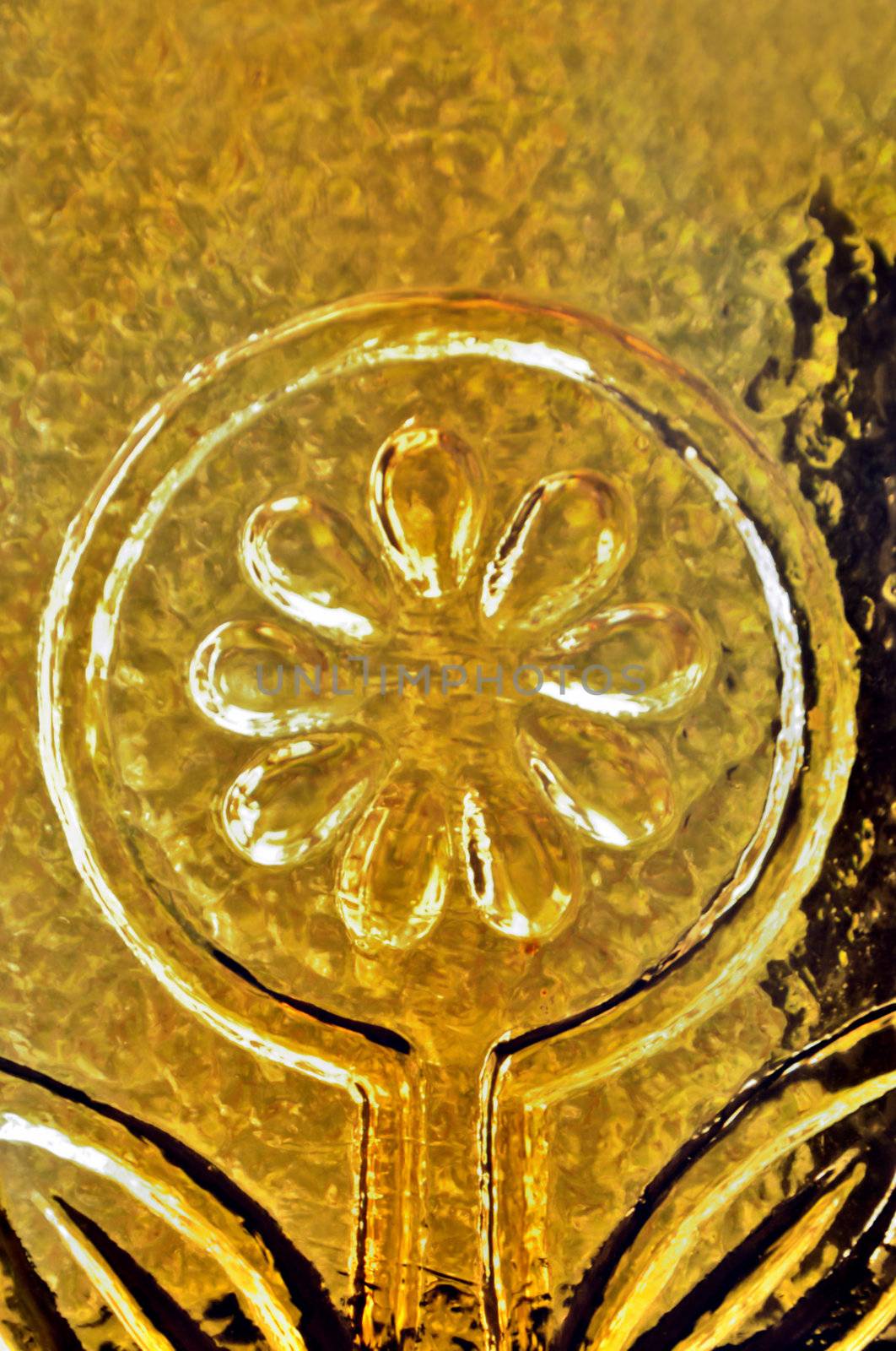 Yellow flower on stained glass and light reflections abstract background.