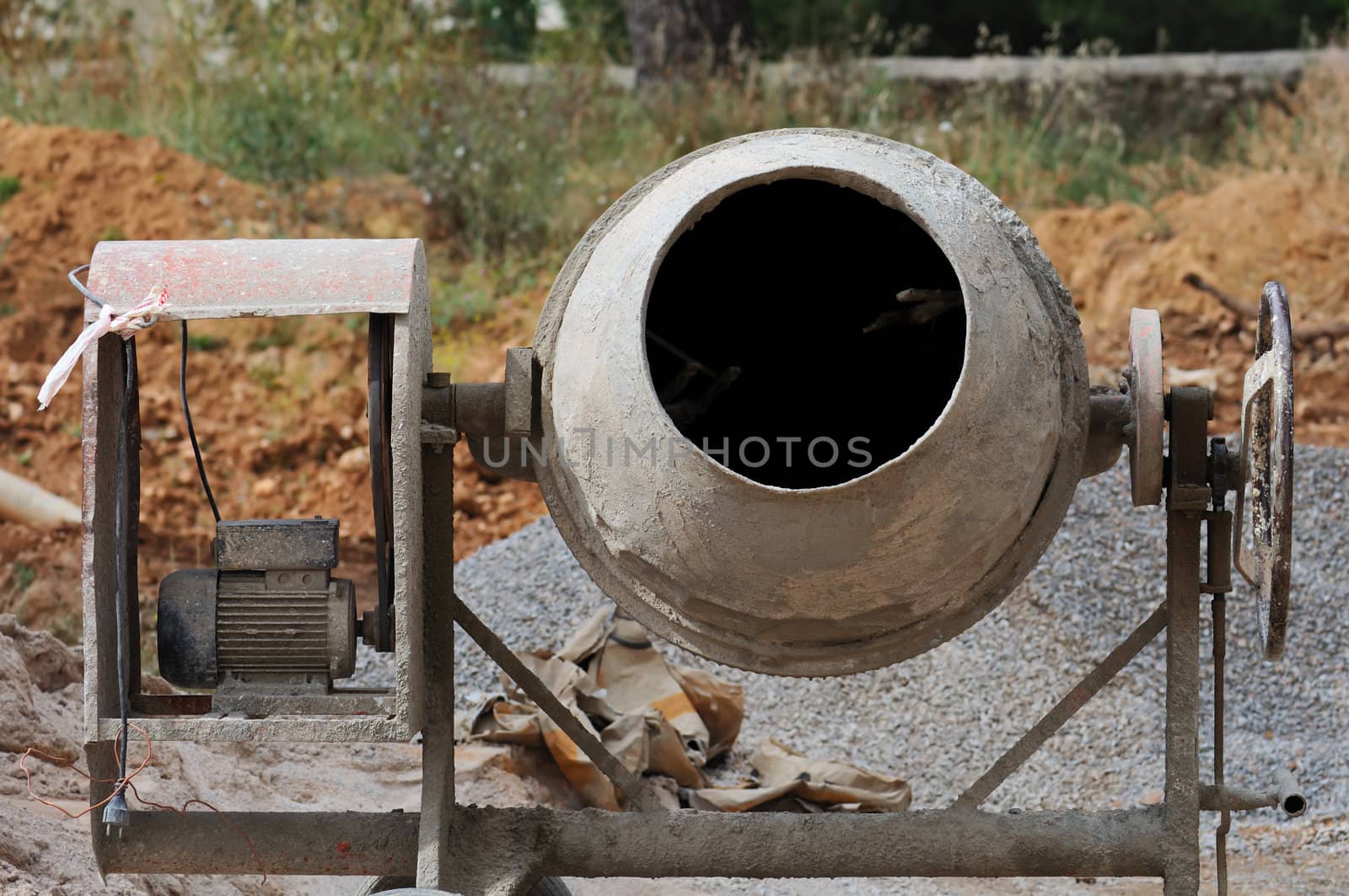 Industrial cement mixer machinery at construction site.