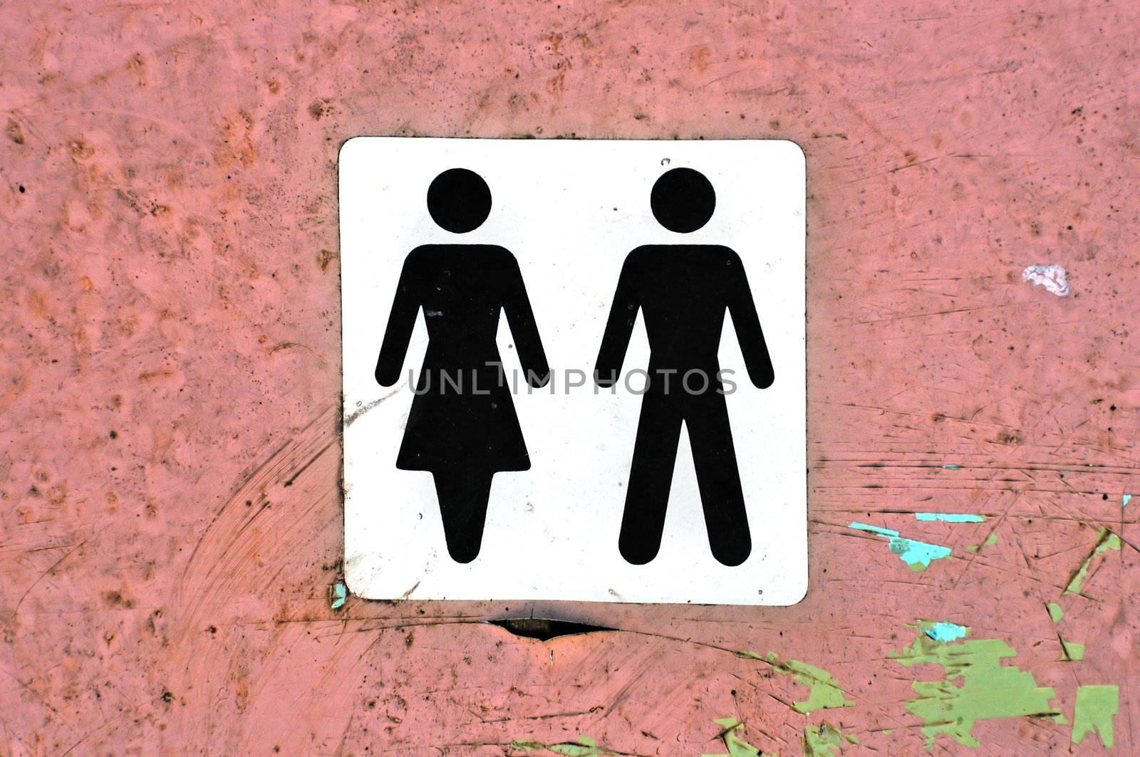 Male female symbol label on grungy wood background texture.