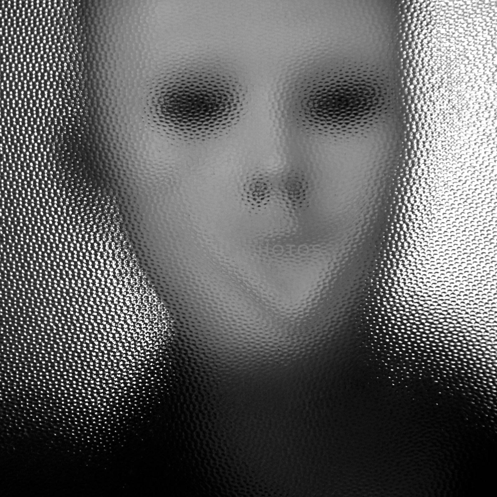 Masked distorted figure behind stained glass surface. Black and white.