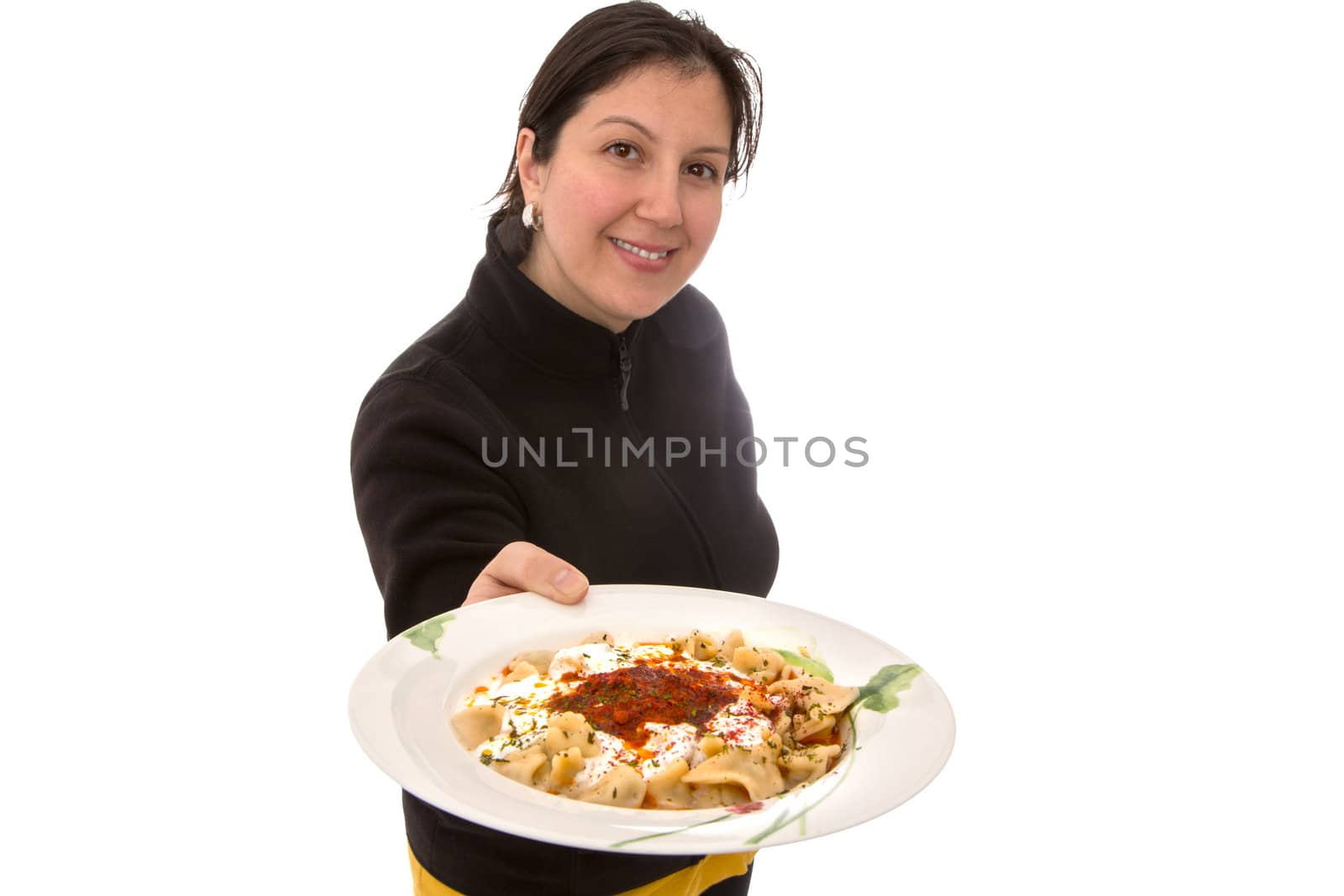 Turkish girl proudly presenting Turkish version of multinational food manti in a plate. Topped with yogurt tomato sauce, parsley flakes and spices. Isolated on white with copy space.