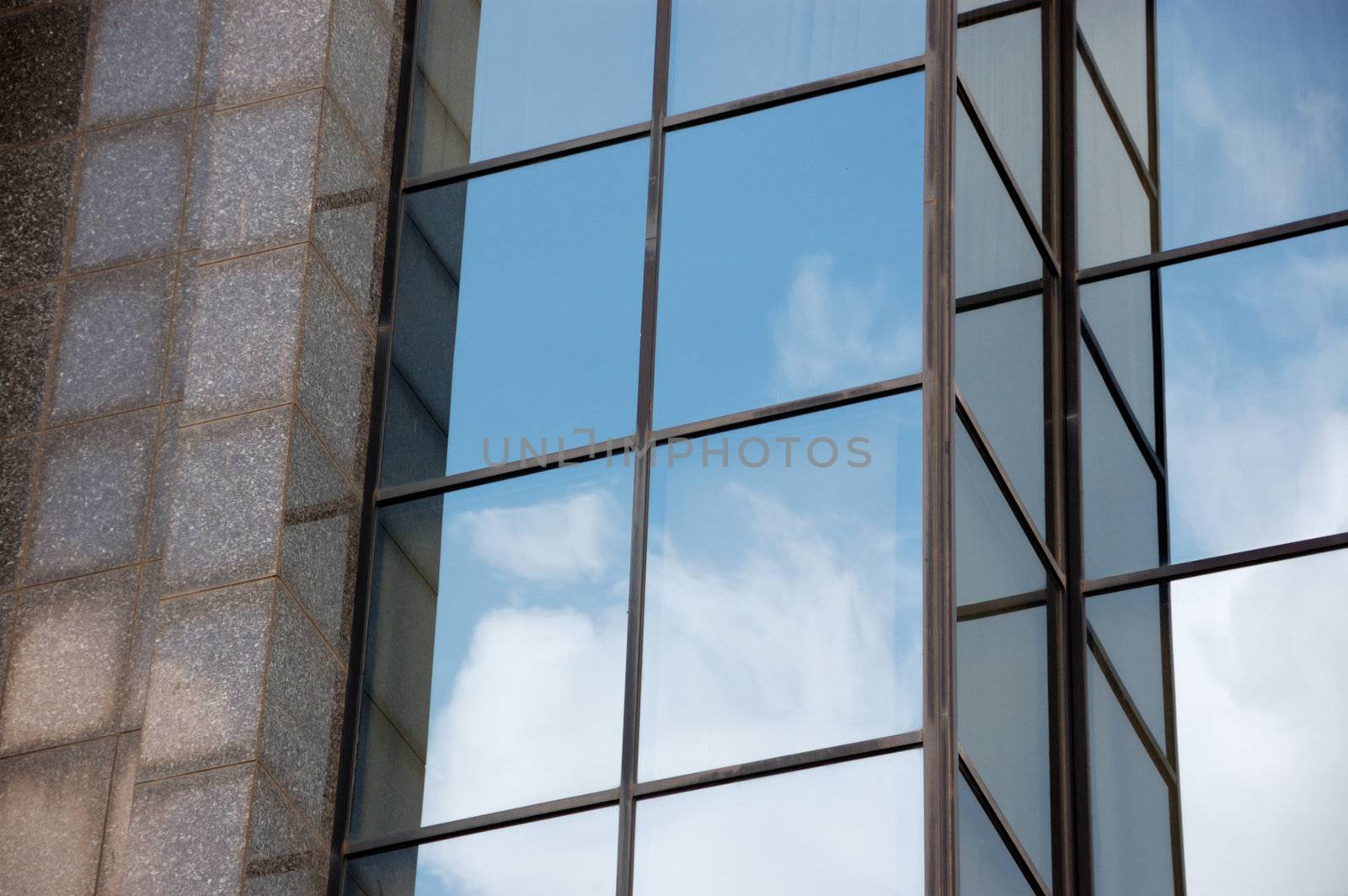 Modern marble and glass facade of high rise building. Architectural background.