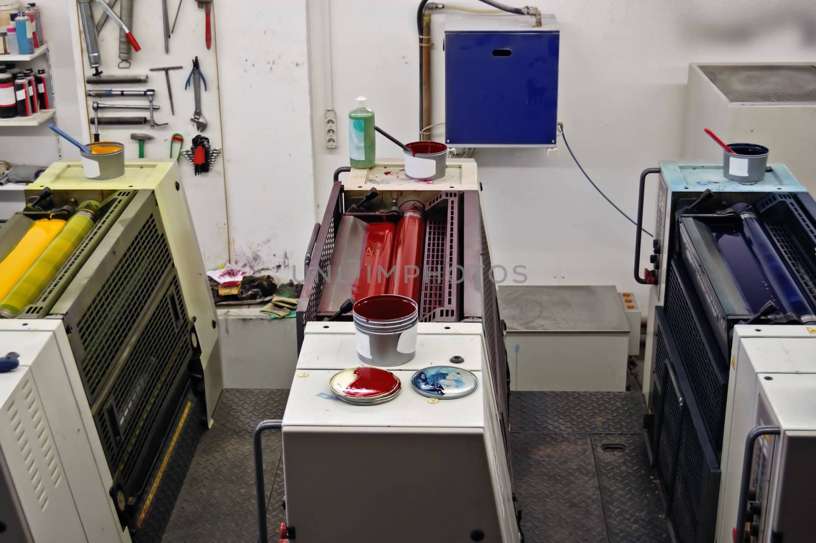 Printing press production line with cmyk colors. Red, blue and yellow ink.
