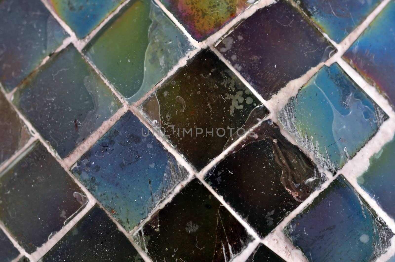 Square pieces of stained glass texture macro. Abstract background selective focus.