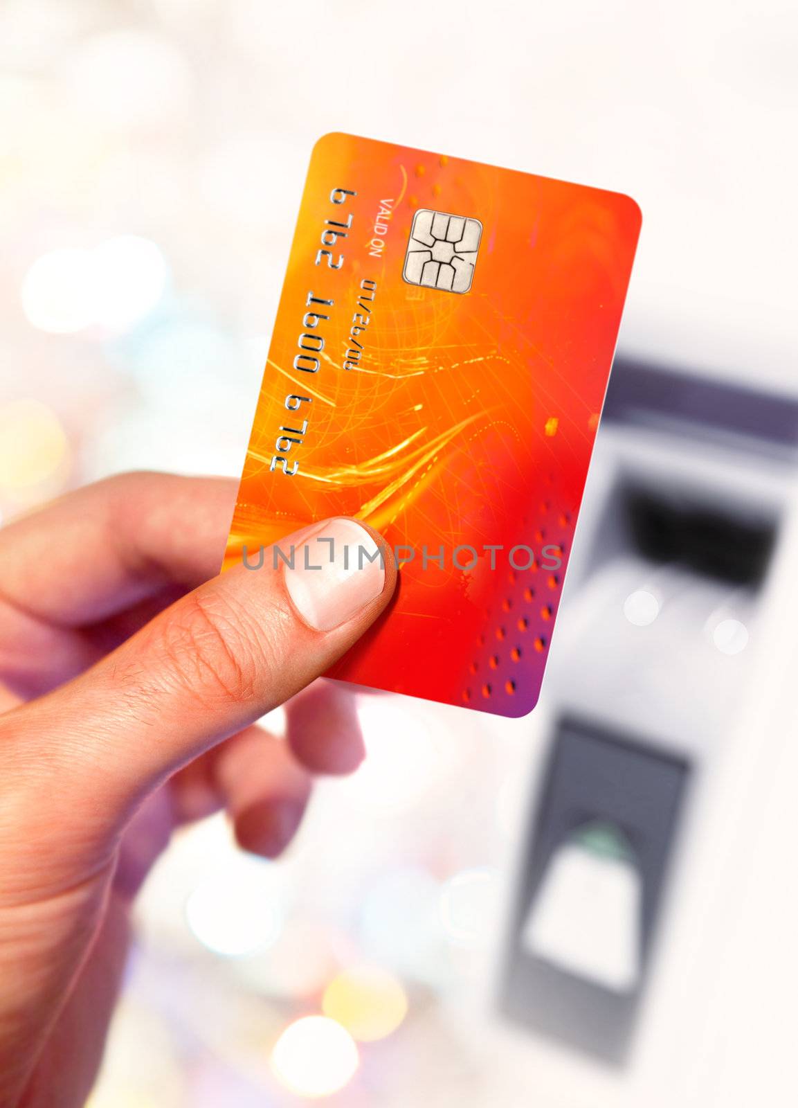 Close-up of man hand holding plastik credit card near ATM