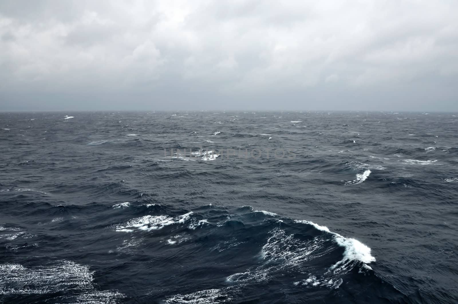 Deep sea water waves and stormy sky.