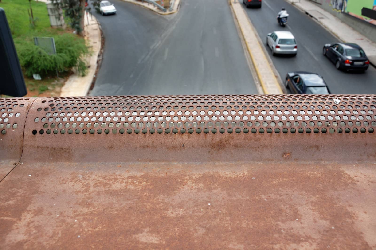 Urban traffic cars on the motorway. Selective focus on the rusty metal texture.