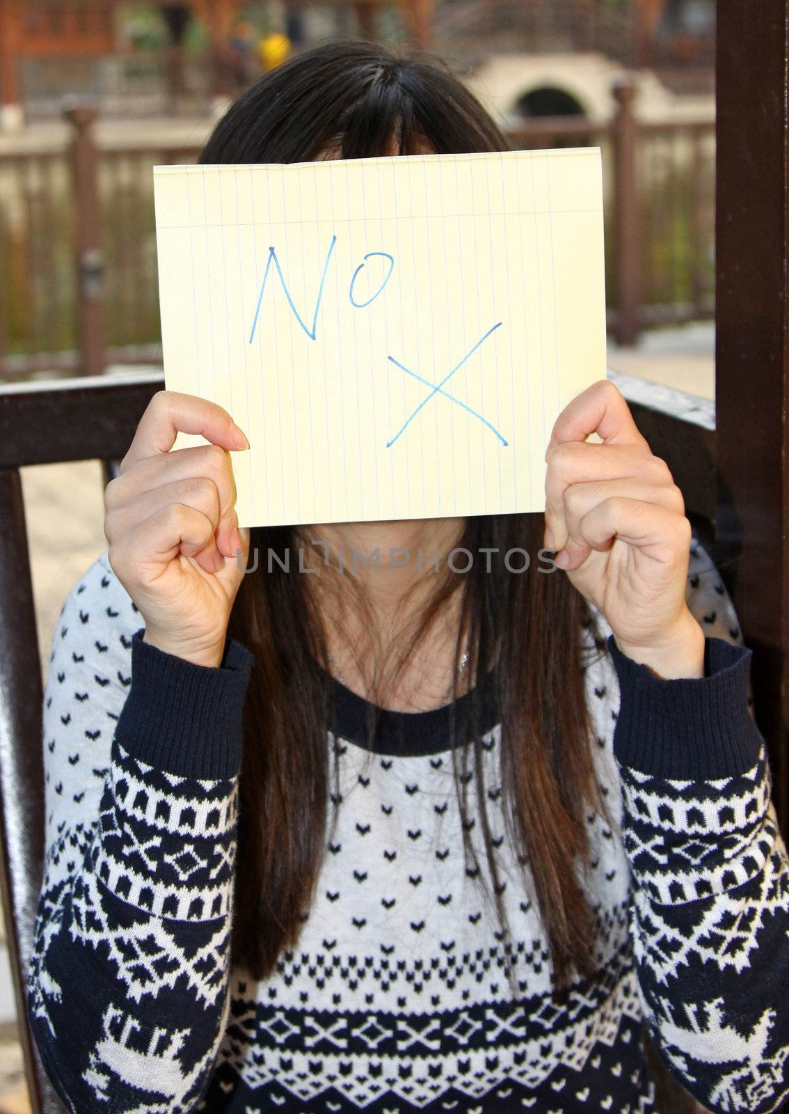 Woman holding NO signage