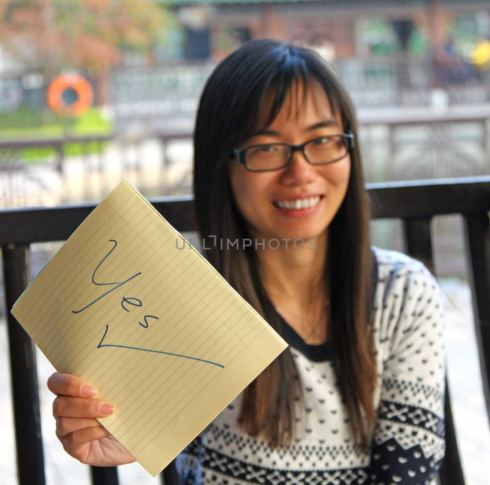 Asian woman with YES sign