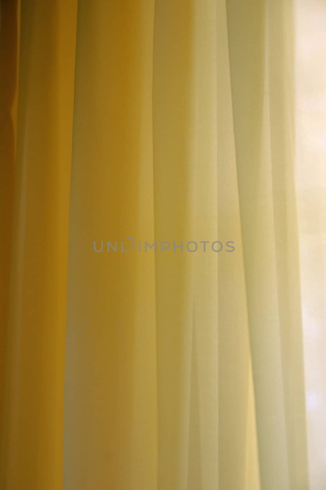 Transparent curtain background texture. Shades of yellow.
