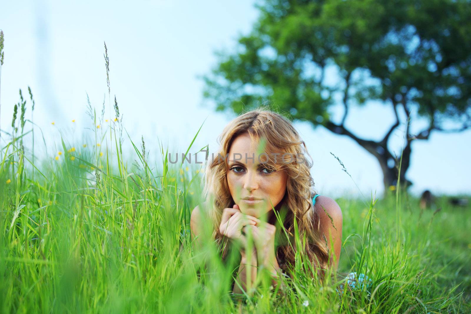  woman on the green grass under tree happy and smile