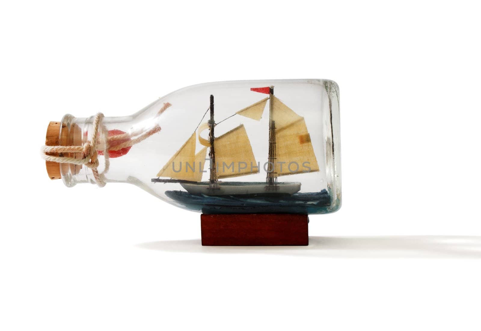 Two-masted ship in a bottle isolated on white background