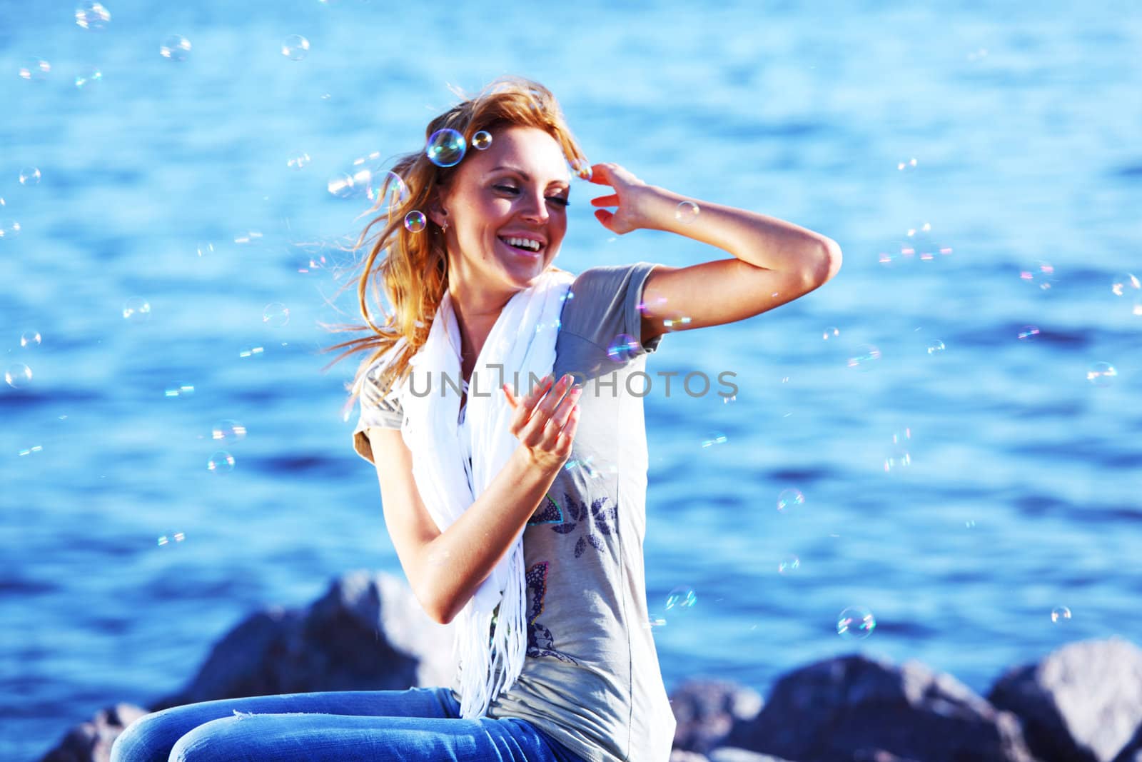 happy blond hair woman sea on background
