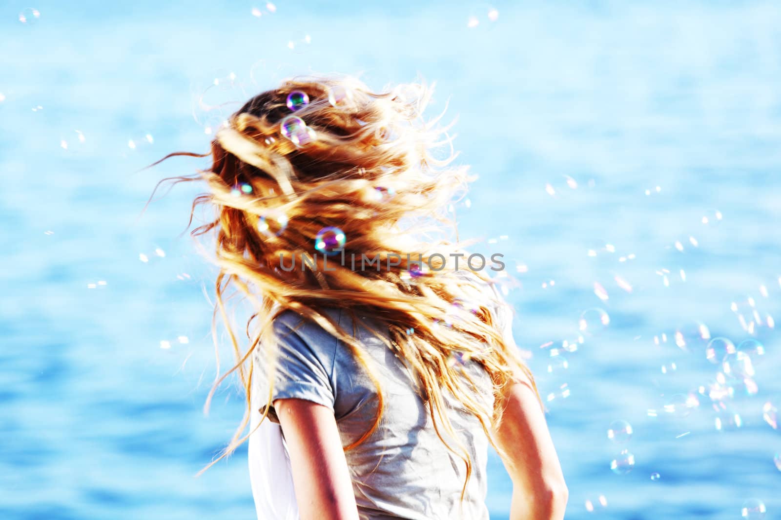 happy blond hair woman sea on background