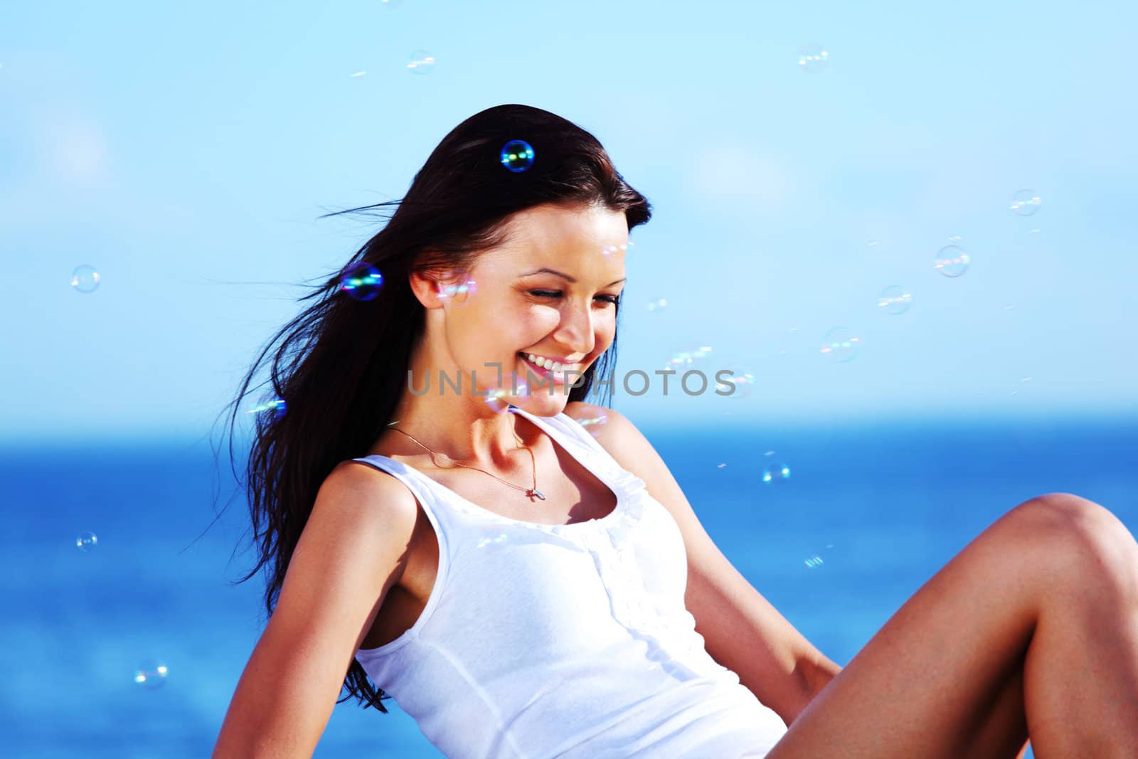  happy brunette hair woman sea on background