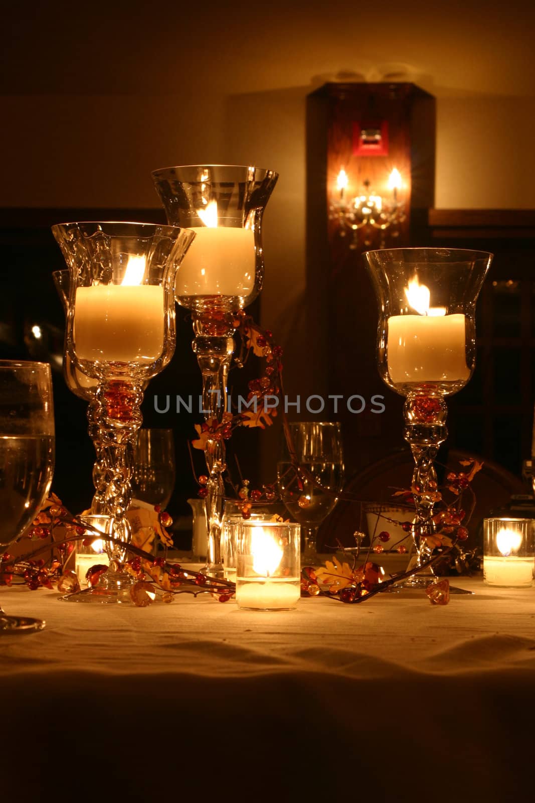 Lit candles decorate a table at a wedding
