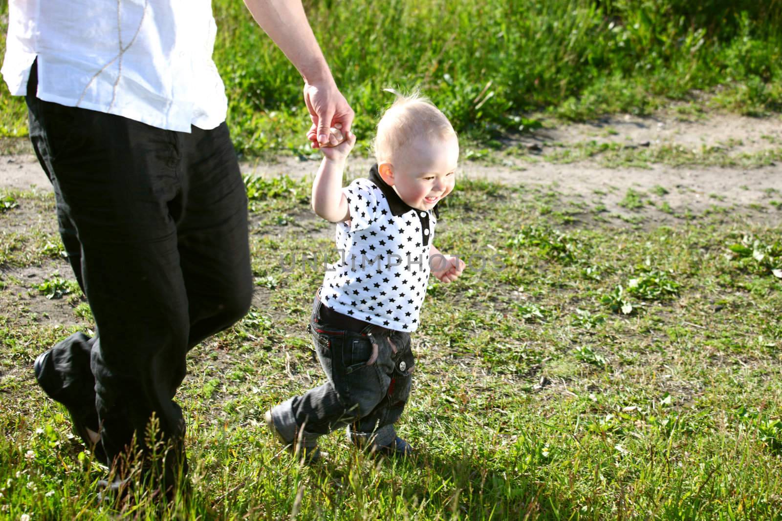 father and son walking on grass
