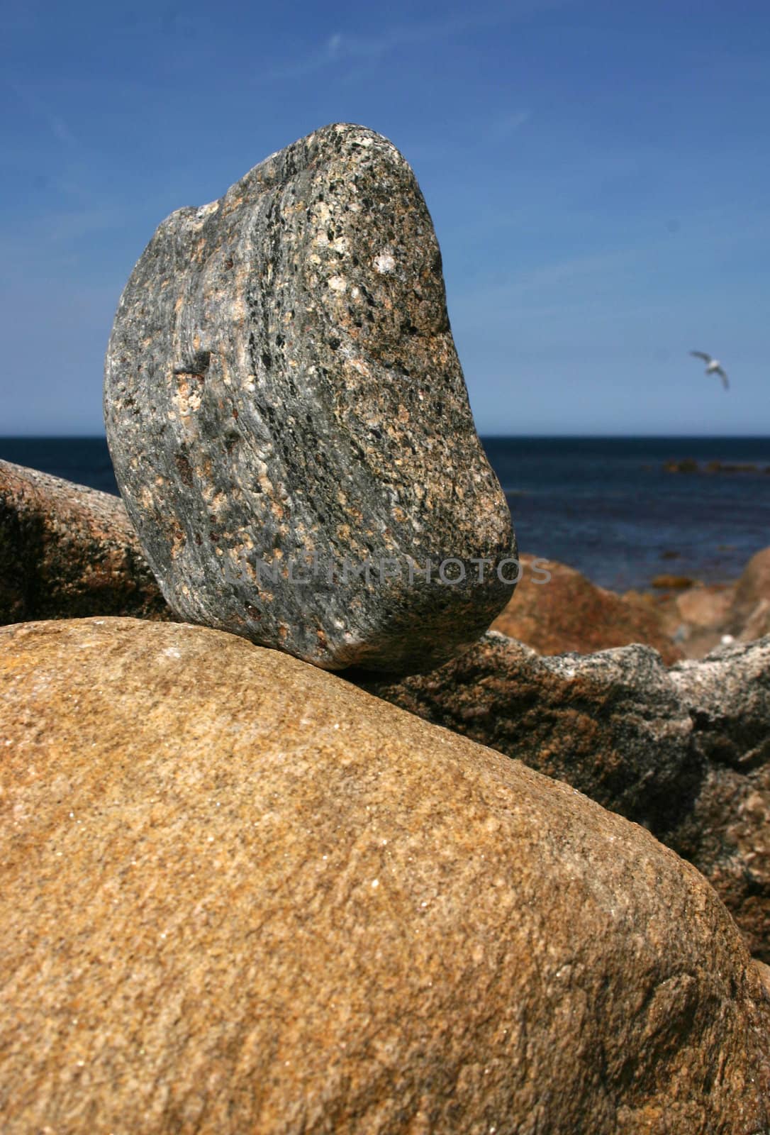 A perched stone on a rocky coastline