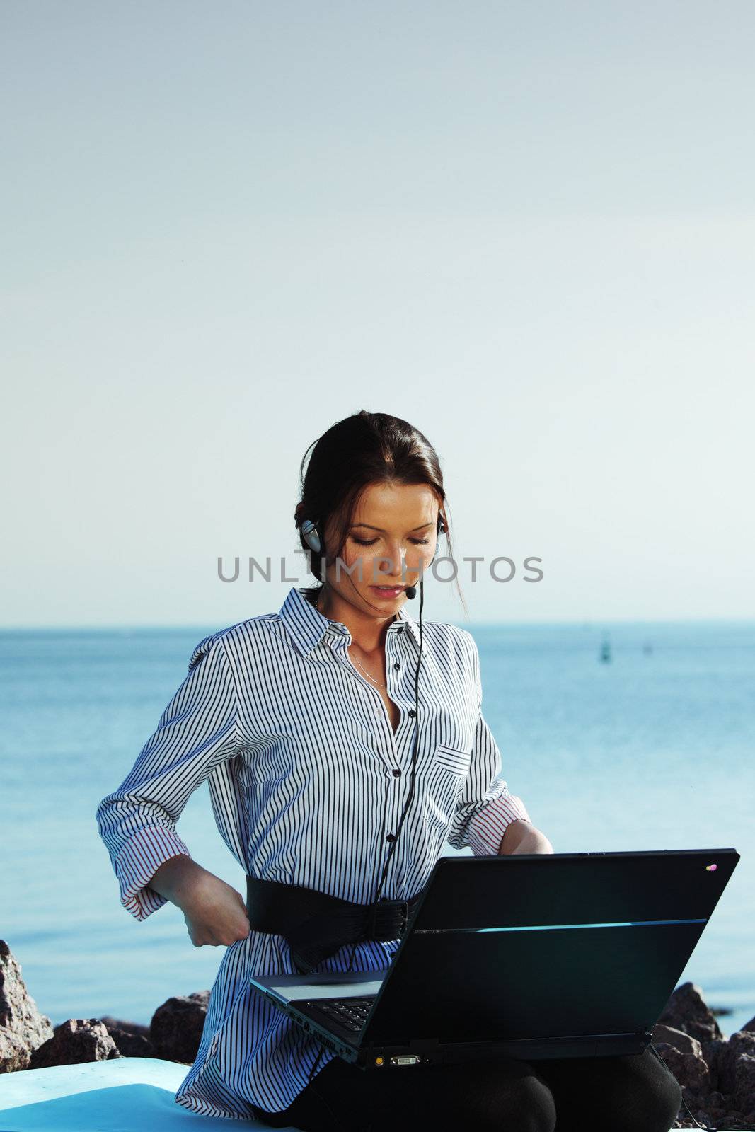 woman with laptop sea background