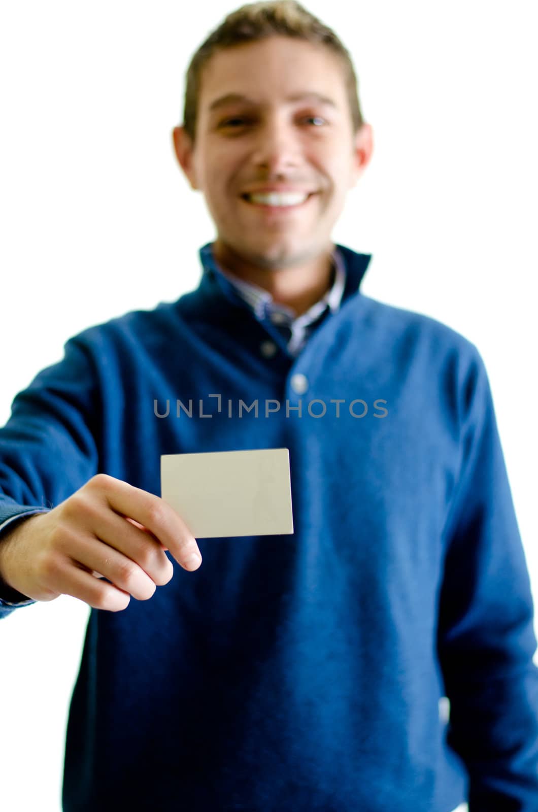Good looking young man showing or giving business card, isolated on white