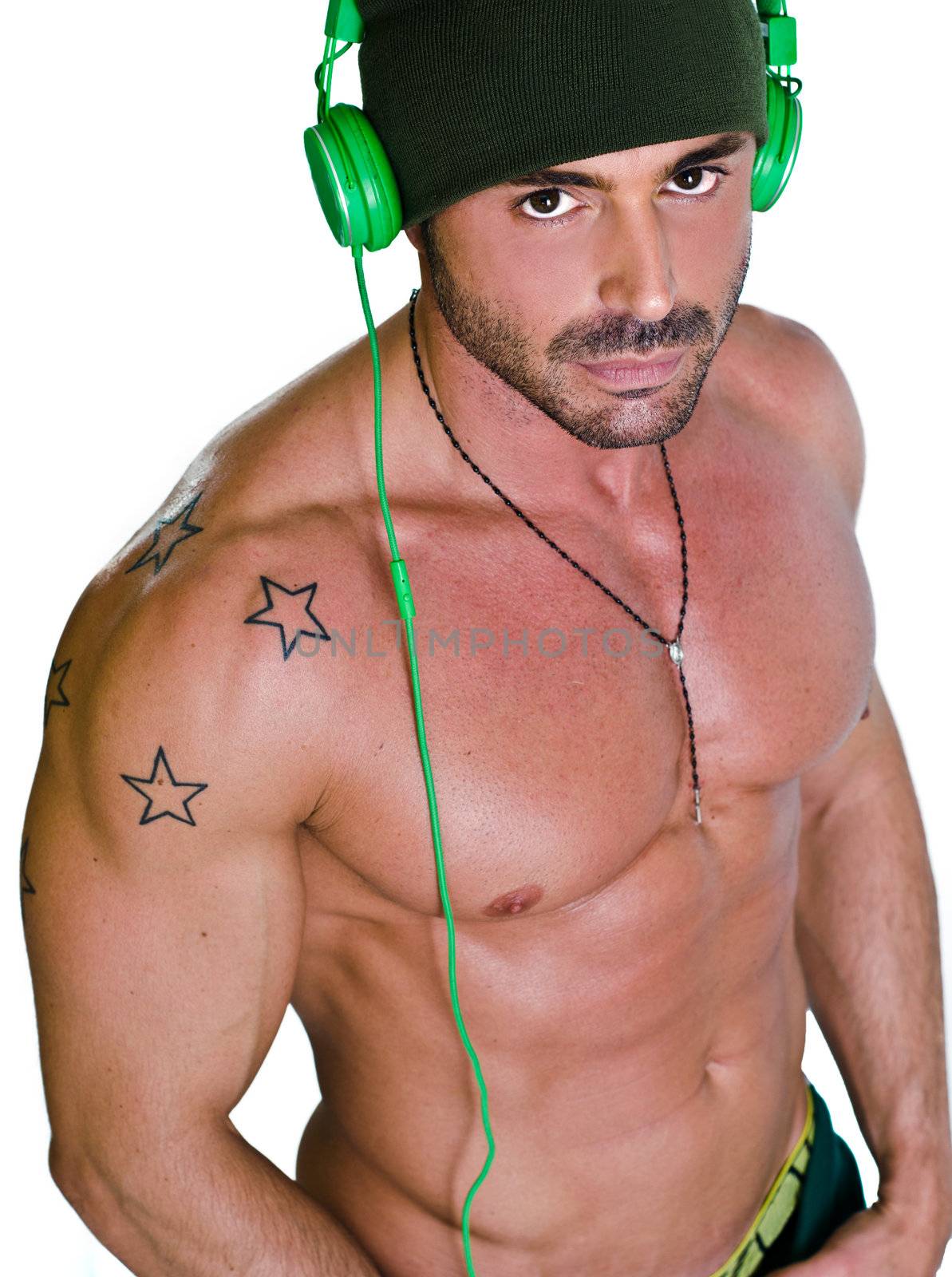 Muscular, athletic, tanned and shirtless man with headphones, isolated on white