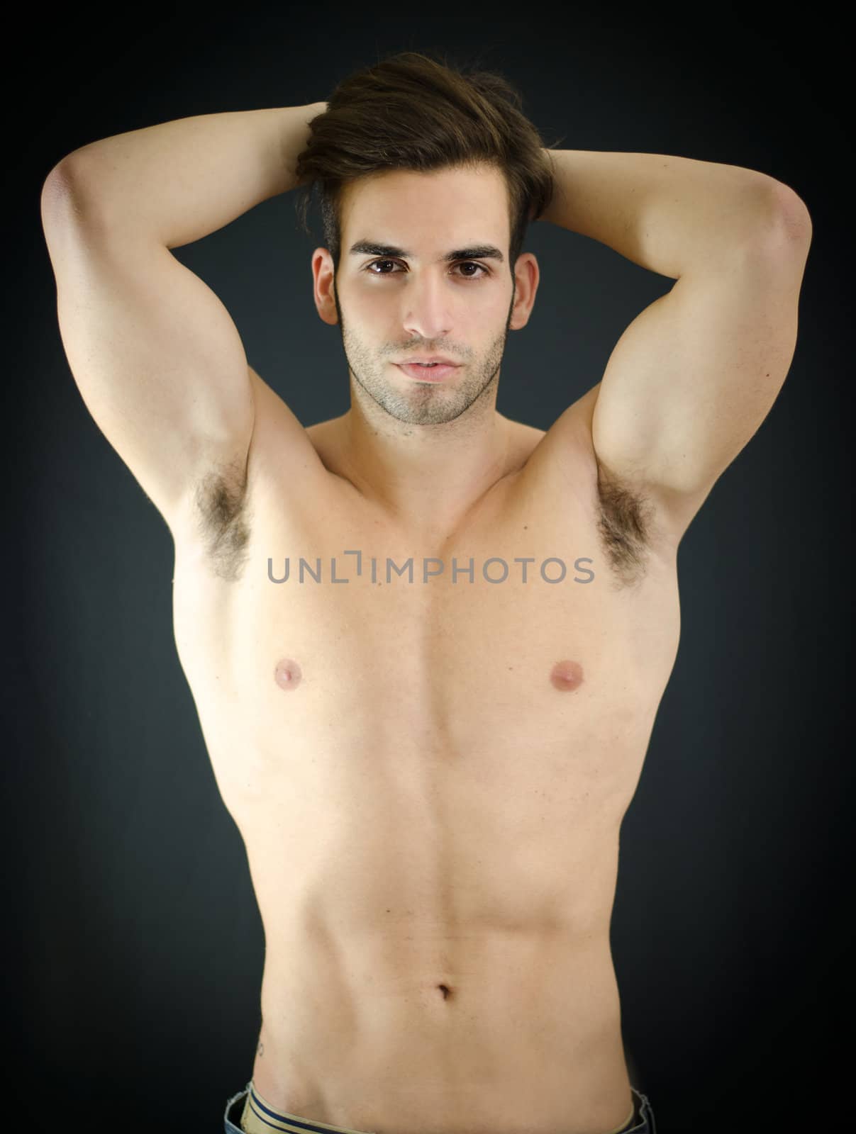 Sexy young man, shirtless, with arms up behind his head by artofphoto